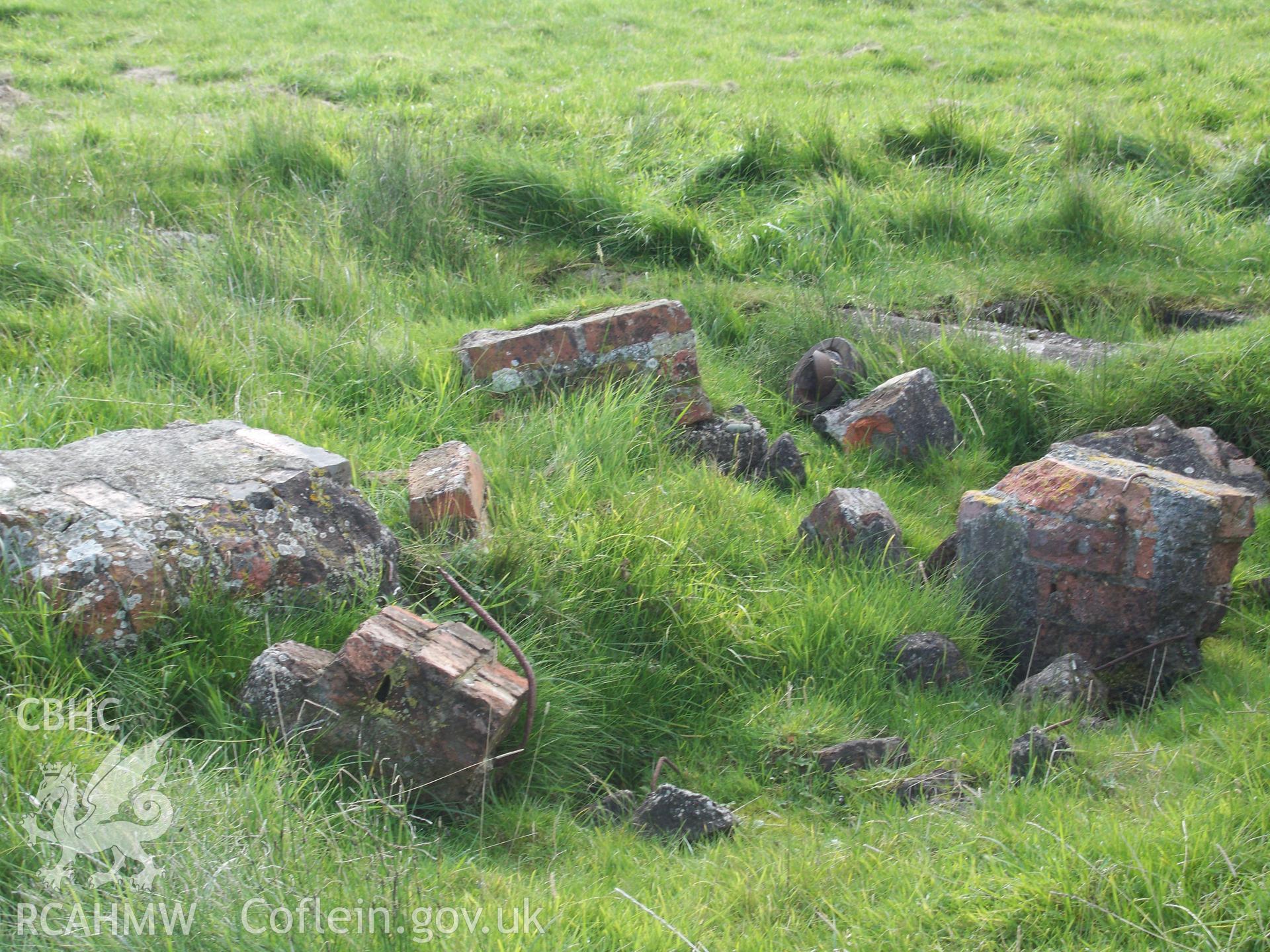 Brick rubble with outline of buildings concrete footings to the rear of view