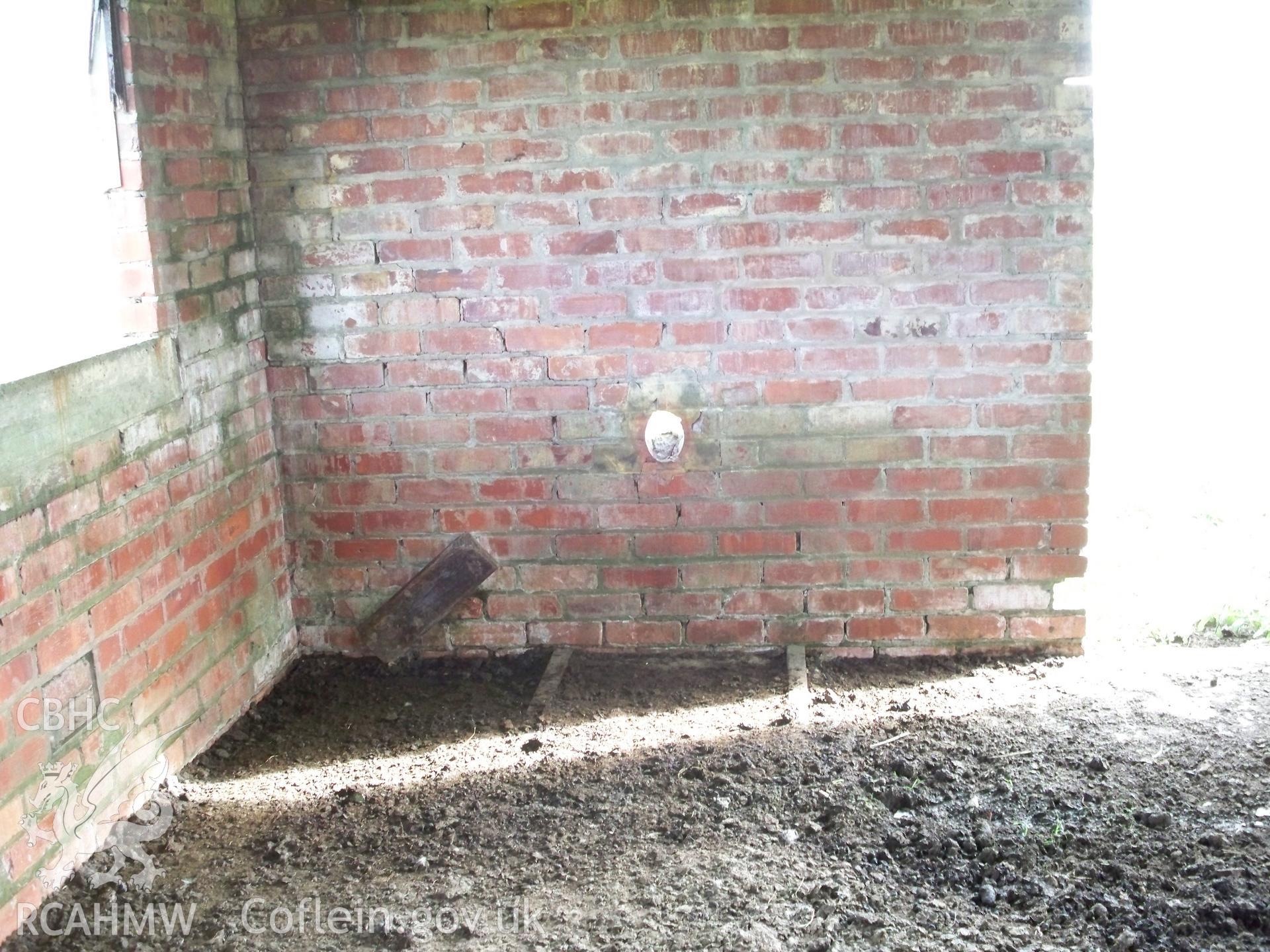 Base and flue vent for stove in western wall (interior view)