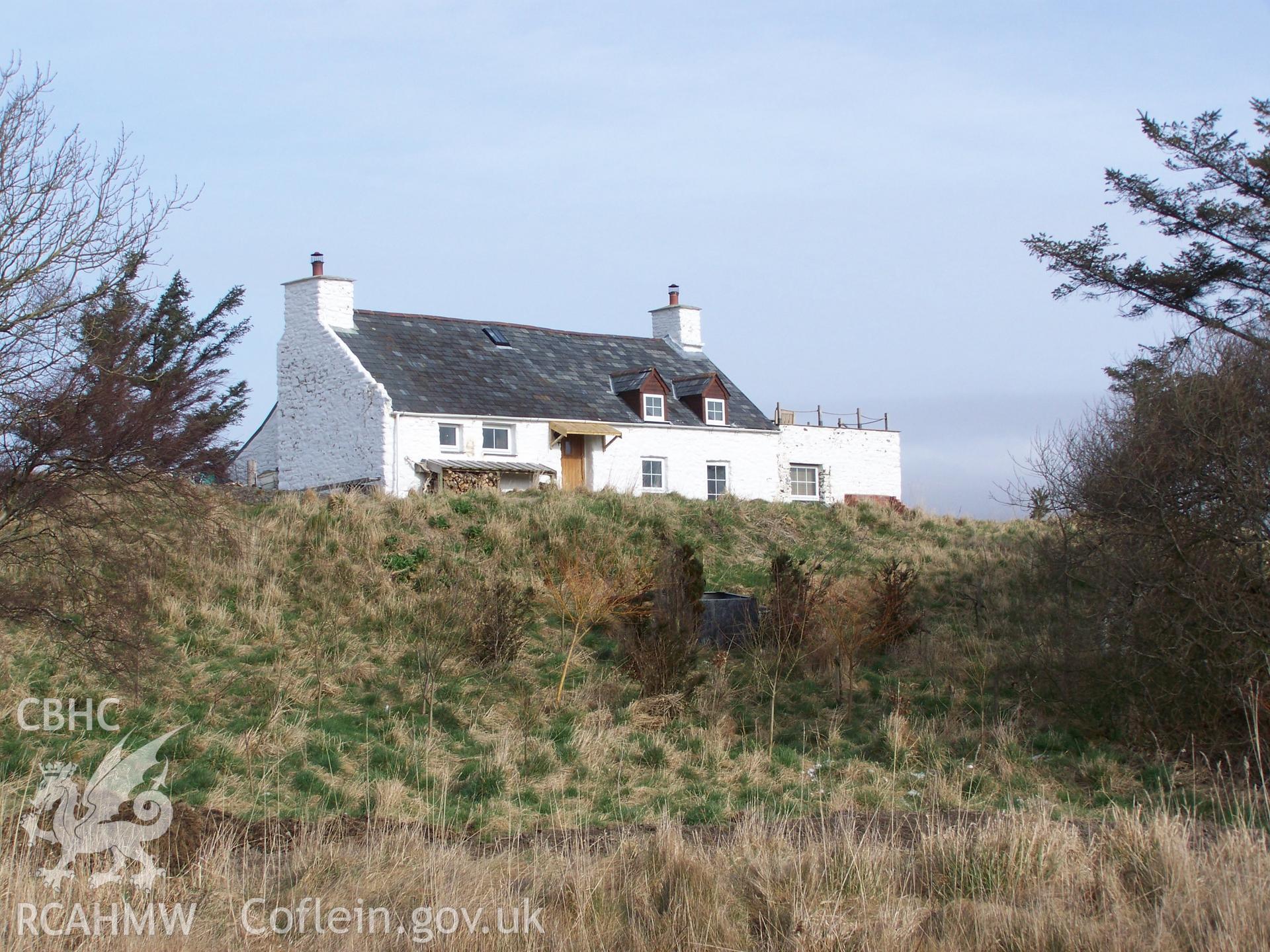 Southern aspect of house and adjoining outbuilding viewed from road.