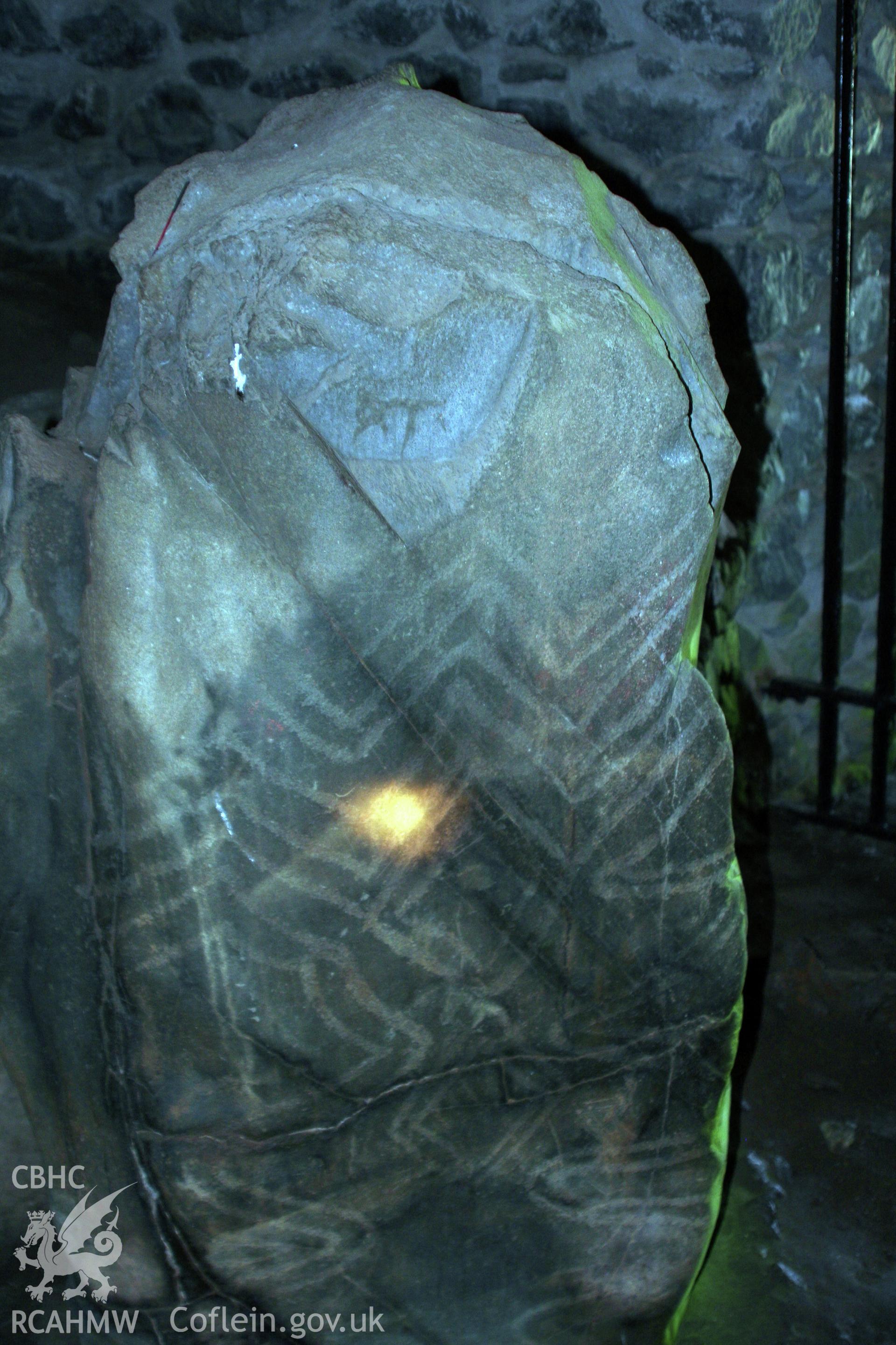 View of carved pillar stone with lozenge, zig-zag, spiral and wavy-line decoration on west side of tomb entrance.