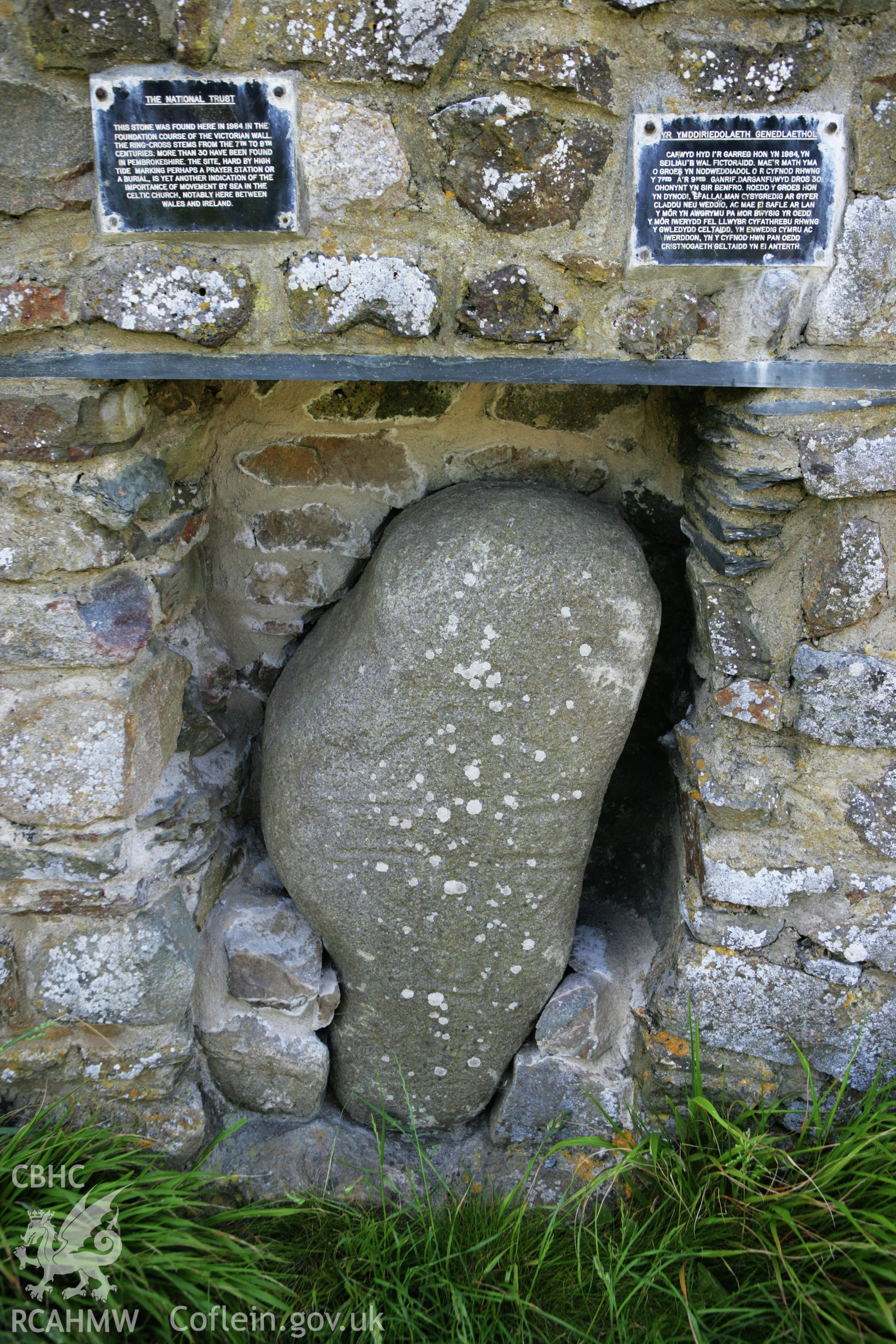 View of inscribed stone and modern signage.