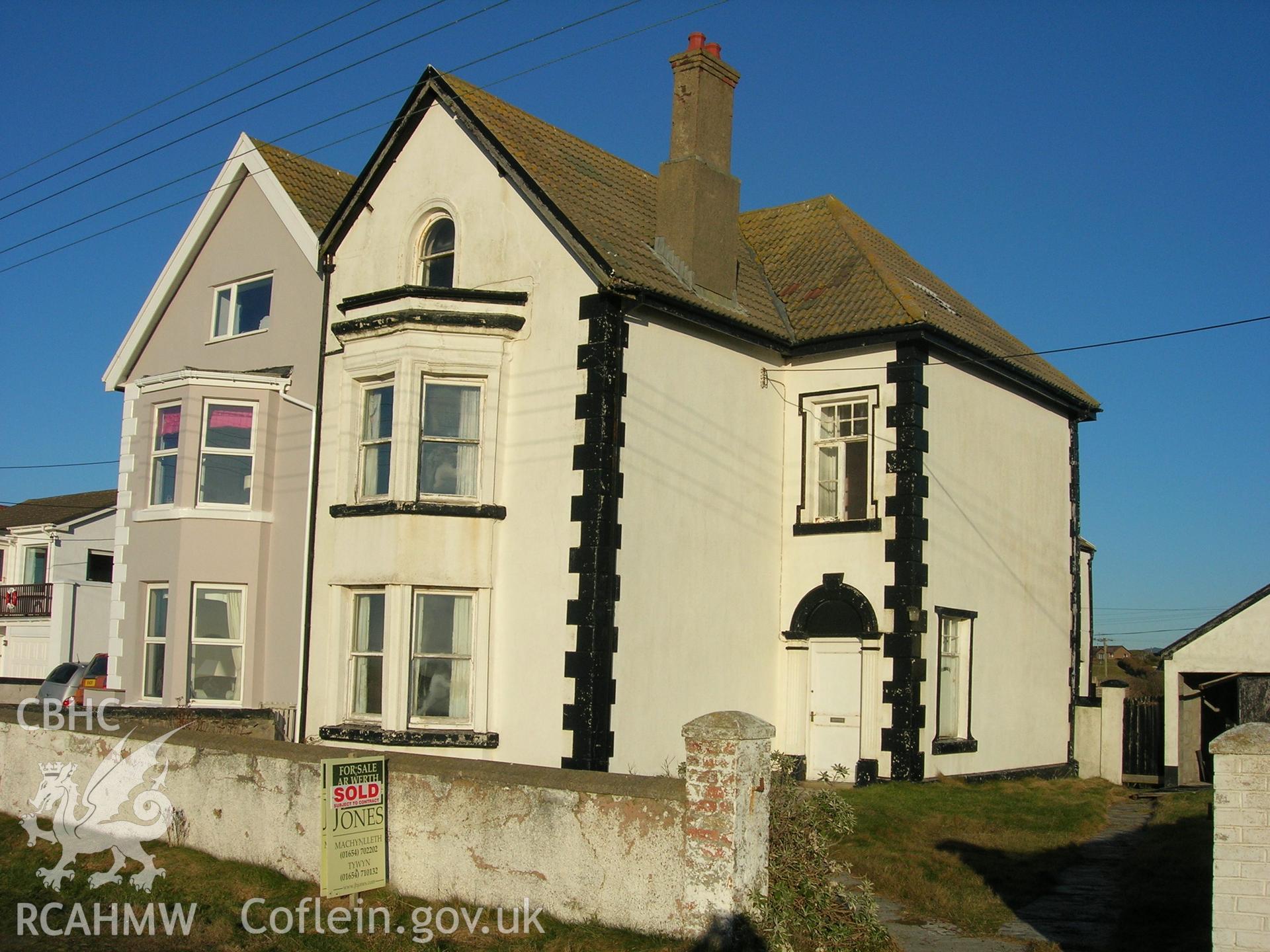 Front elevation viewed from road and southwest