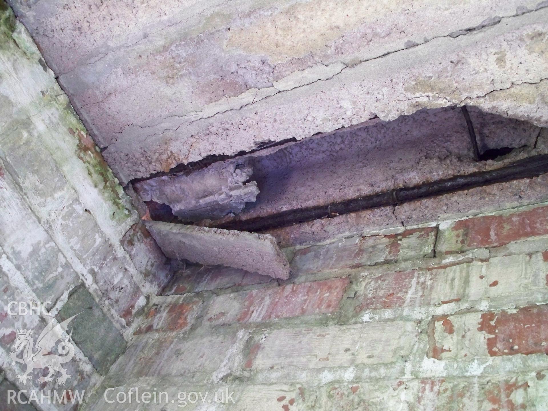 Underside of concrete roof revealing internal structure and reinforcing rods