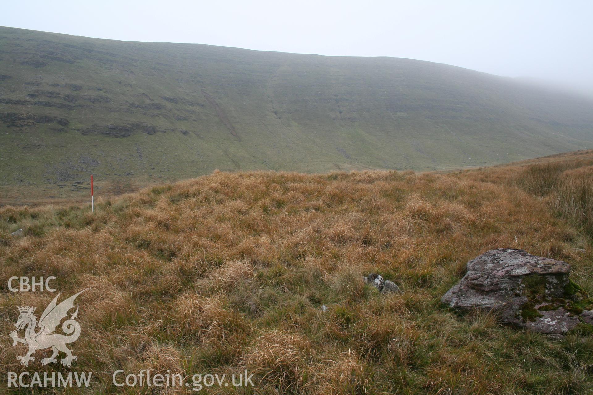 Mound seen from the south-east with rising escarpment of Fan Hir behind; 1m scale.