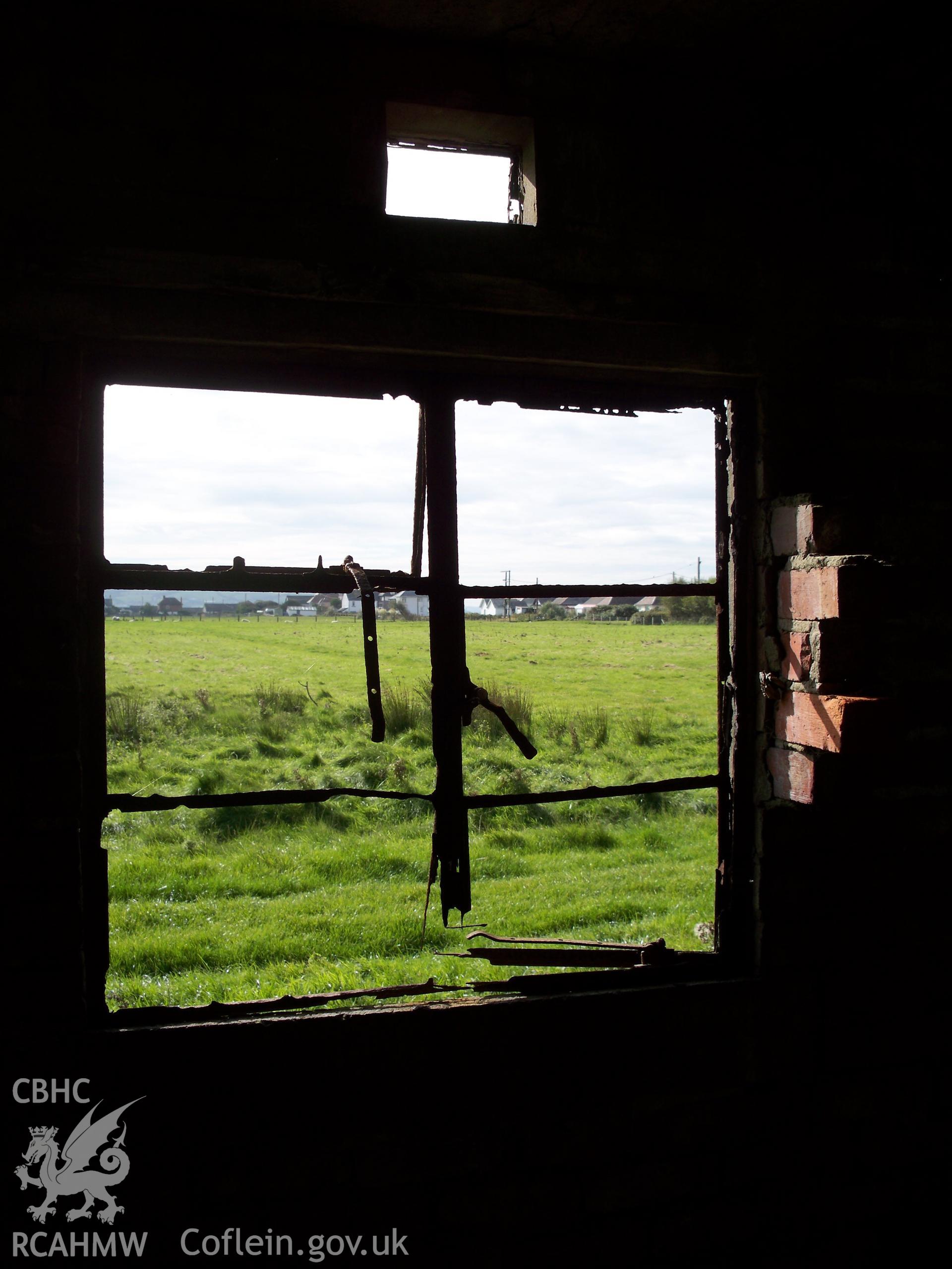 View from southern window which retains its metal framing (vent above) and which abuts the collapsed brick interior partition