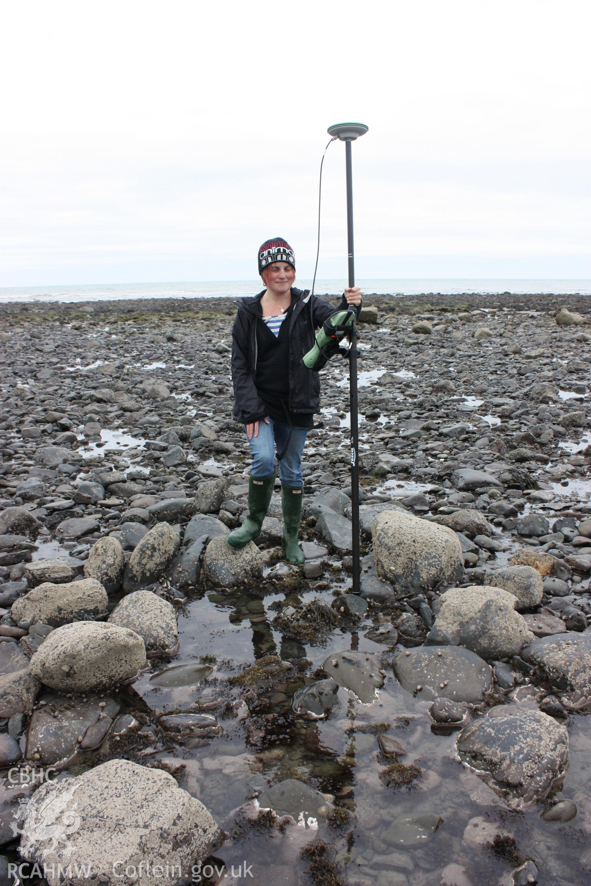 Centre of fish trap arm. Well preserved cod end or sluice, looking west.  RCAHMW staffmember giving indication of scale.