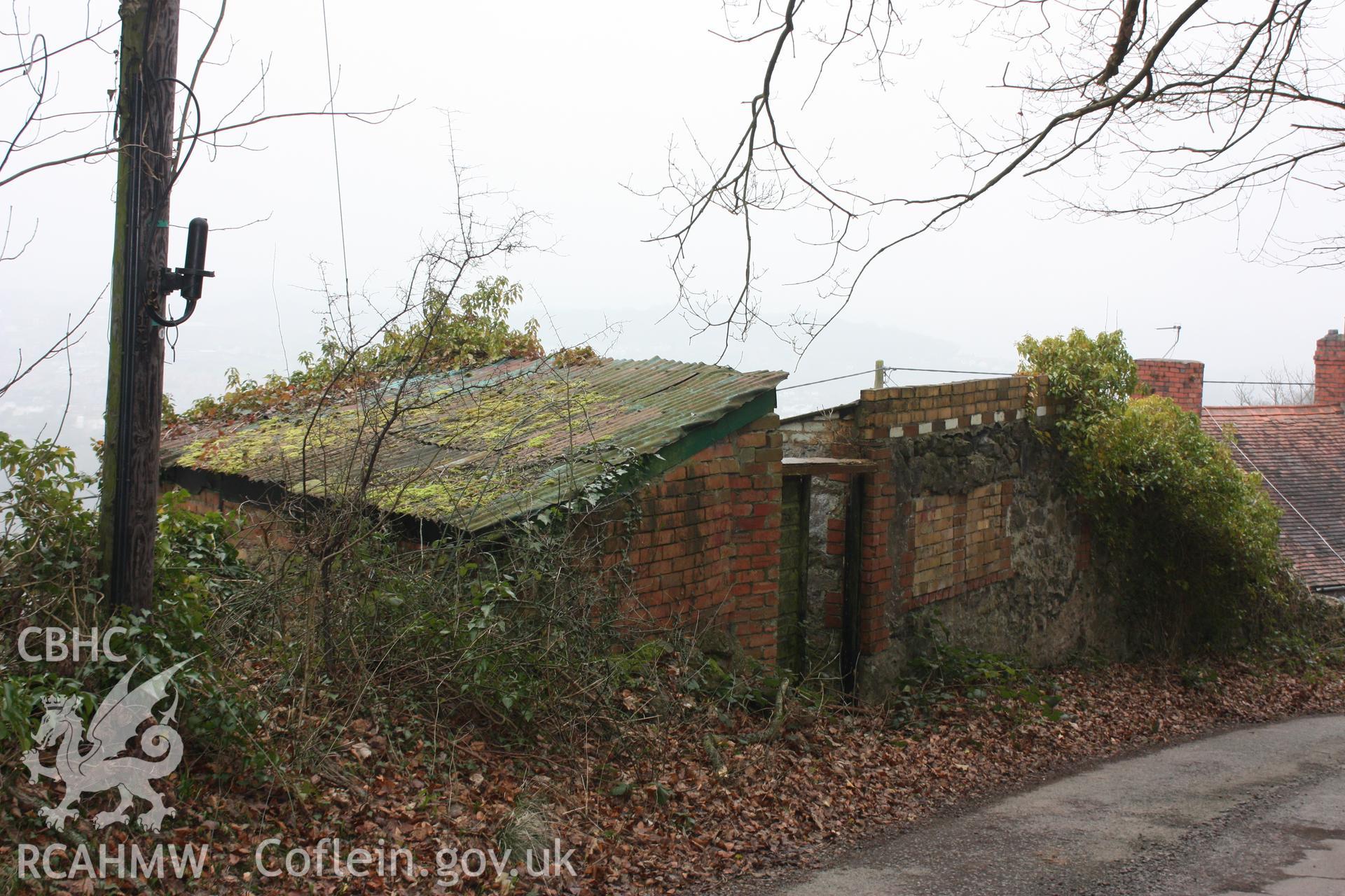 Mid-nineteenth century buildings by the side of the Pen-y-graig quarry road. They are associated with houses immediately below the road.