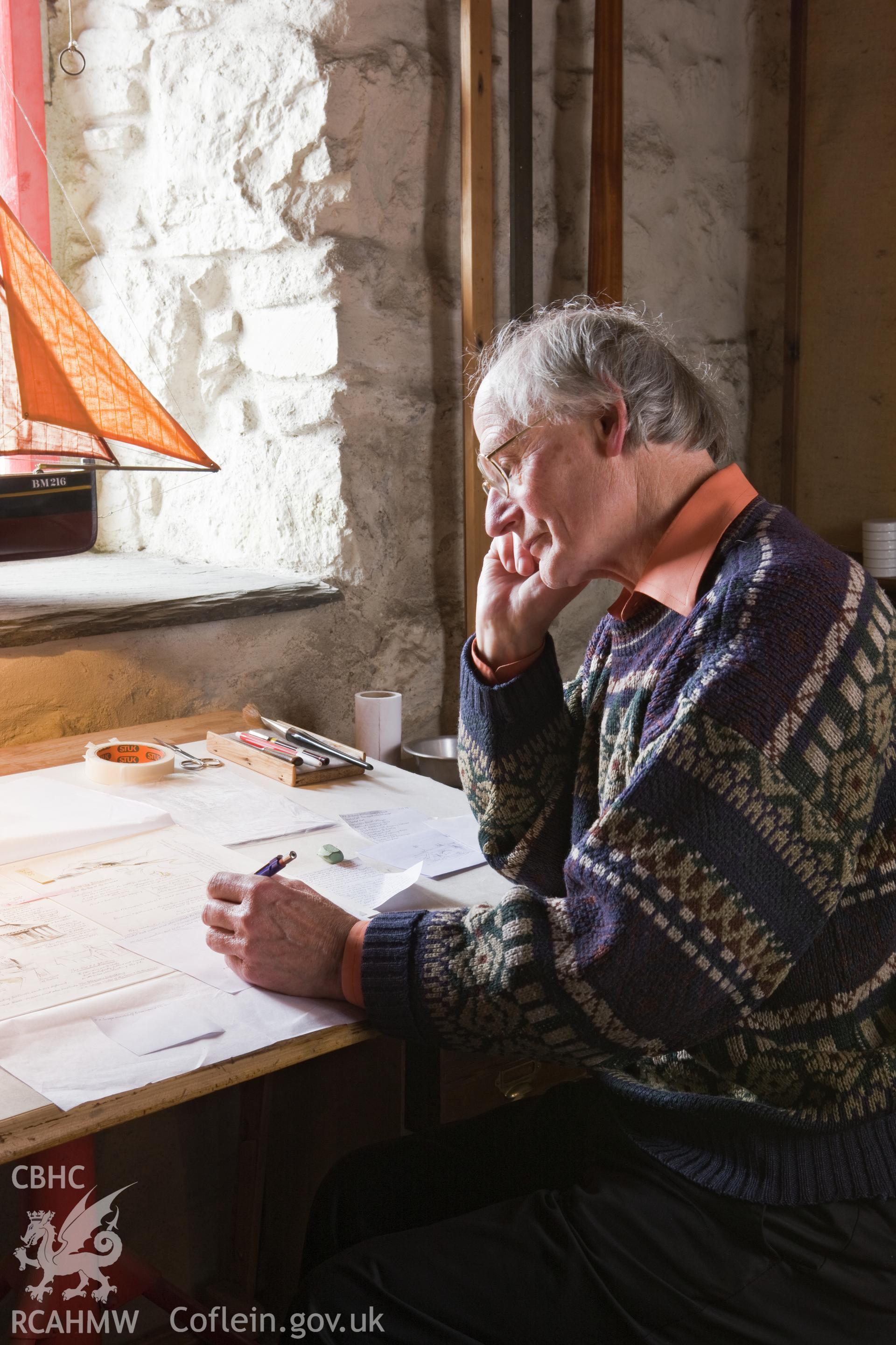 Falcon Hildred at his drawing board.