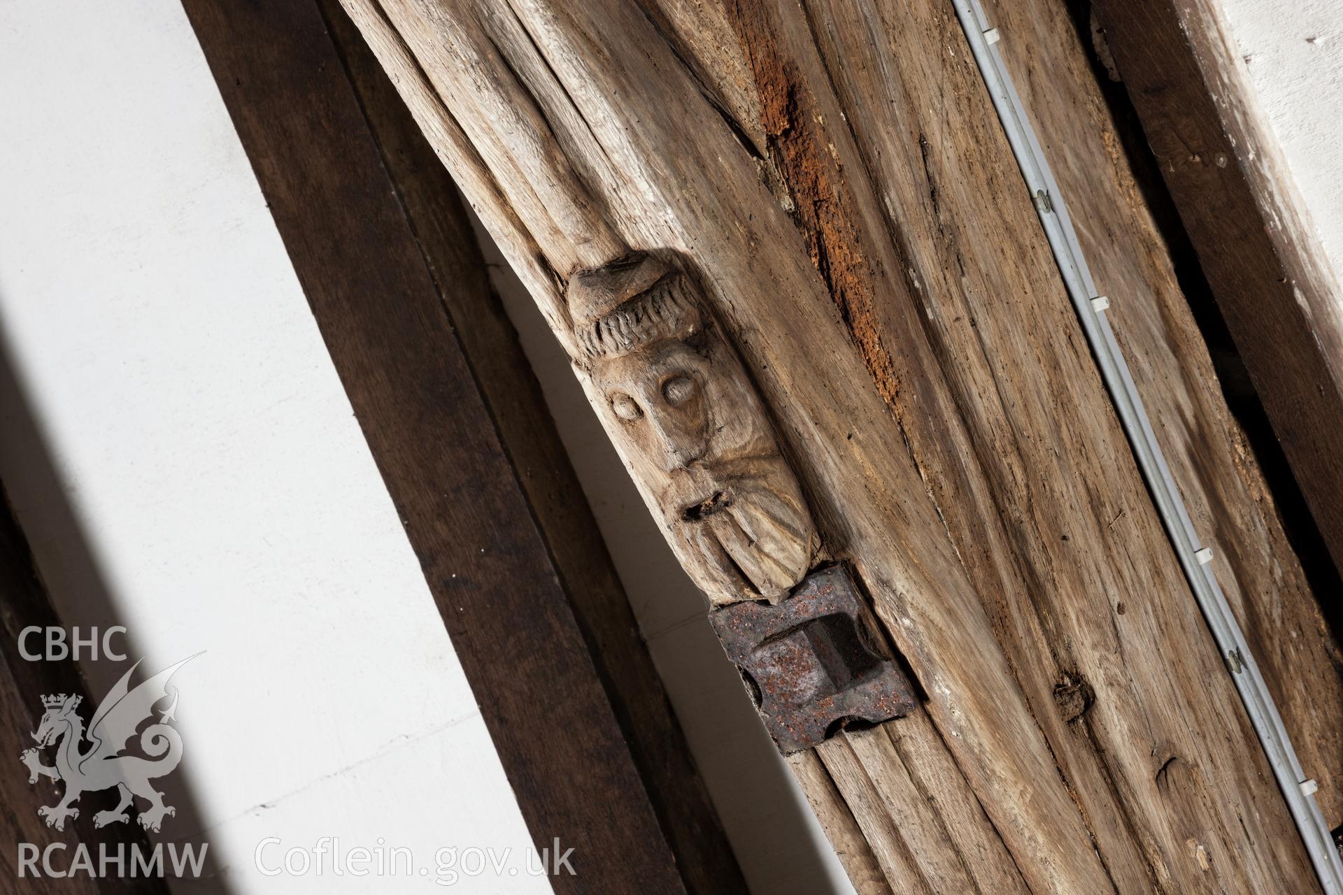 Carved head on third truss