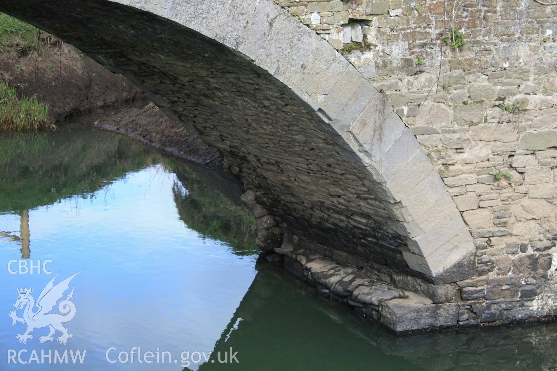 South elevation; underside of bridge arch and abutment looking east