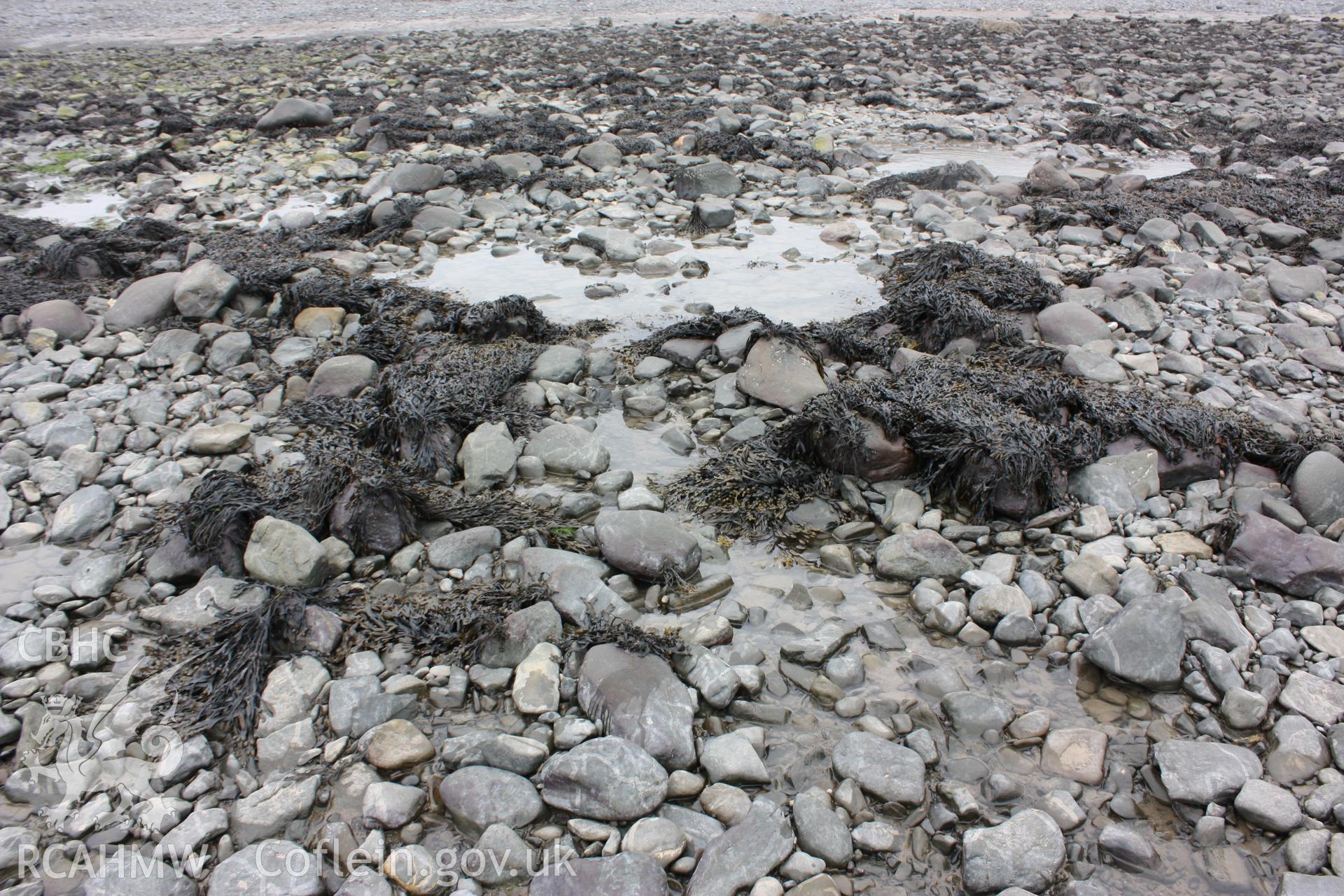 West or seaward side looking east. Larger boulders, roughly aligned into rectangular lines showing possible seaward facing and back walls with break for a net.