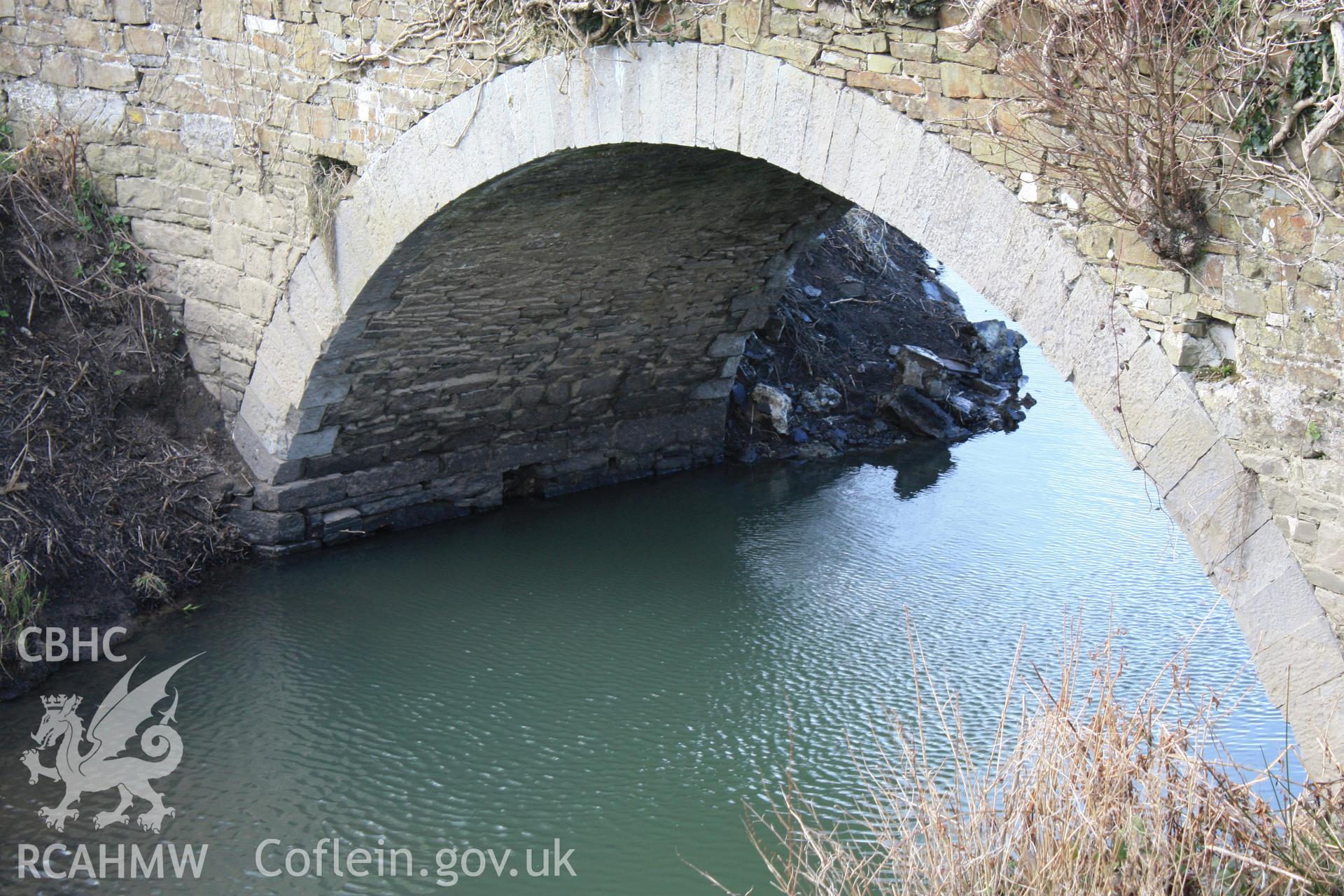 South elevation; underside of bridge arch and abutment looking west