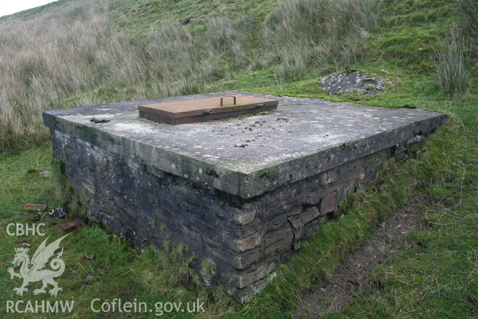 Digital image of Rhaslas Pond and the surrounding area: View  of the filter house from the base of the dam.