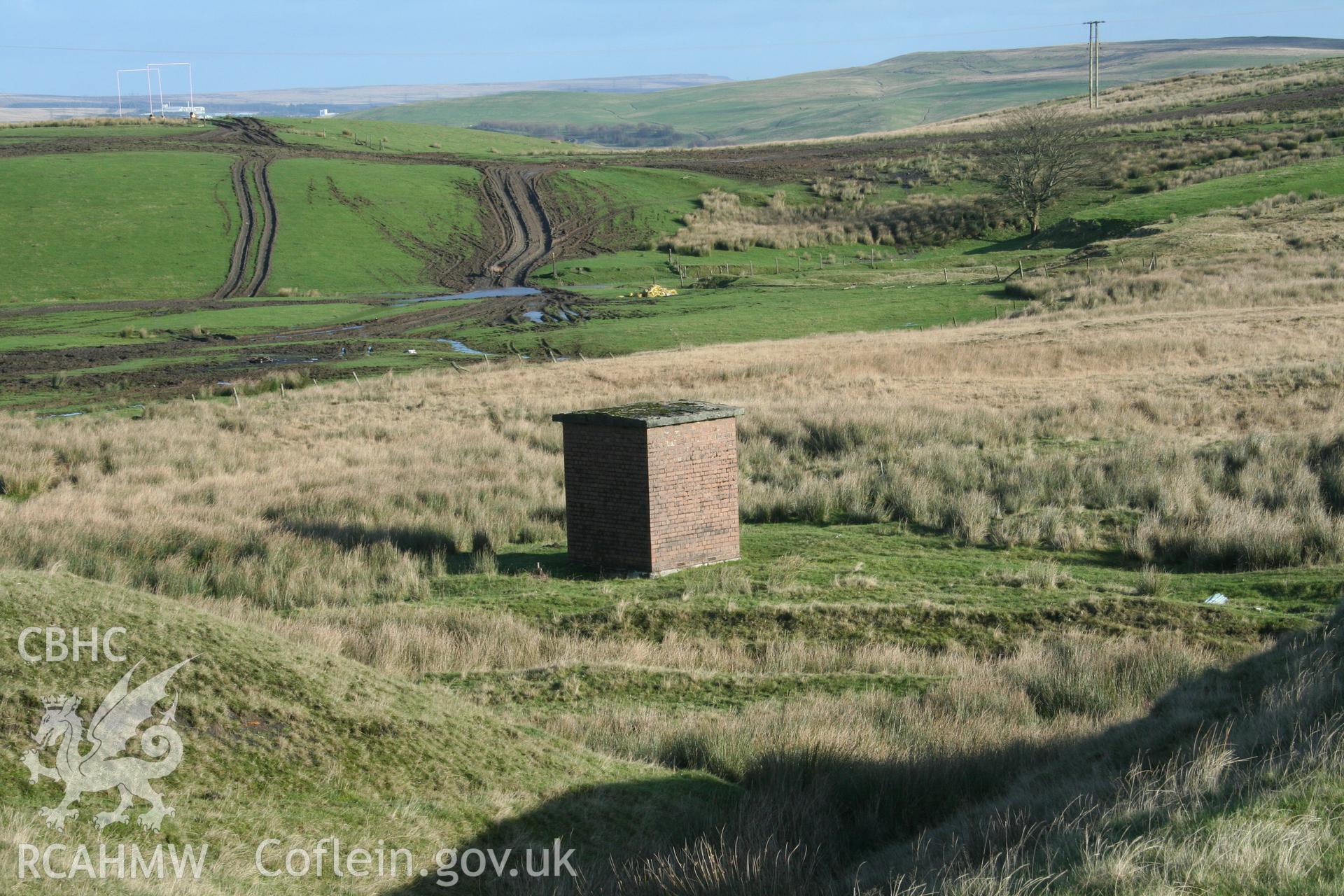 Digital image of Rhaslas Pond and the surrounding area: View of the valve house from the top of the dam, looking north east.