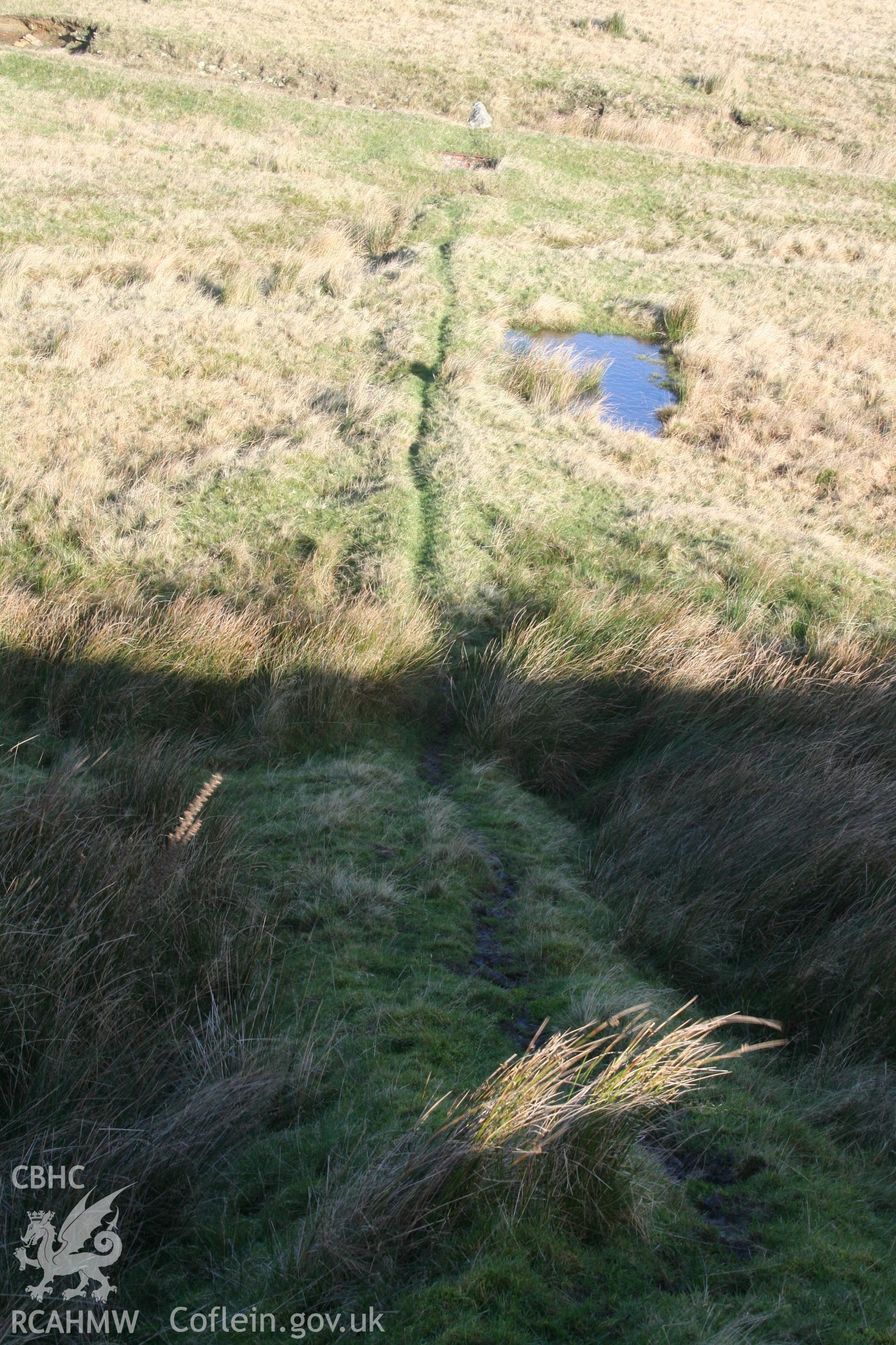 Digital image of Rhaslas Pond and the surrounding area: View of the pipeline from the top of the dam.