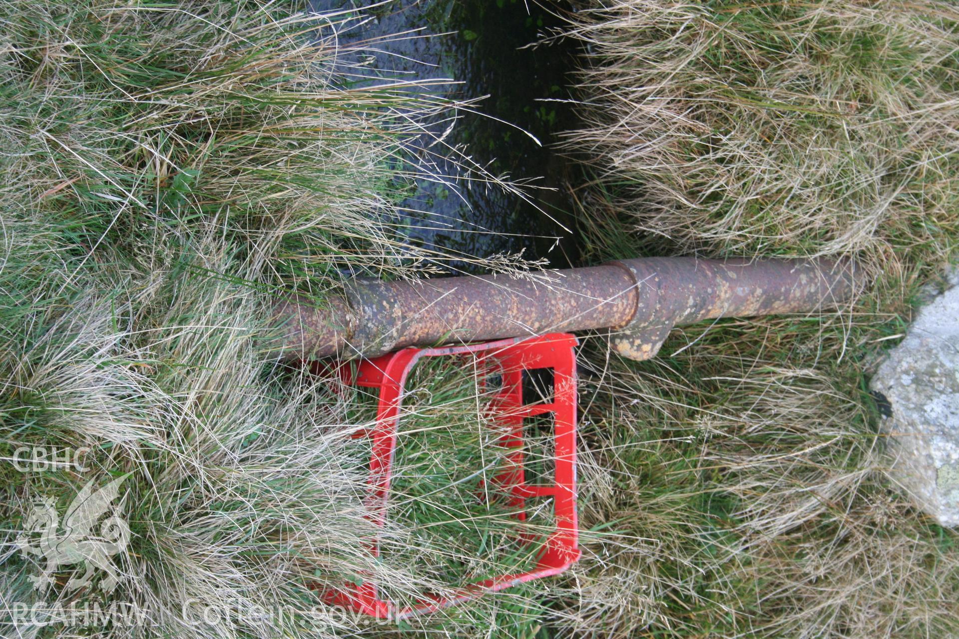 Digital image of Rhaslas Pond and the surrounding area: View  of the pipeline as it crosses the leat (at grid ref: SO0953307416).