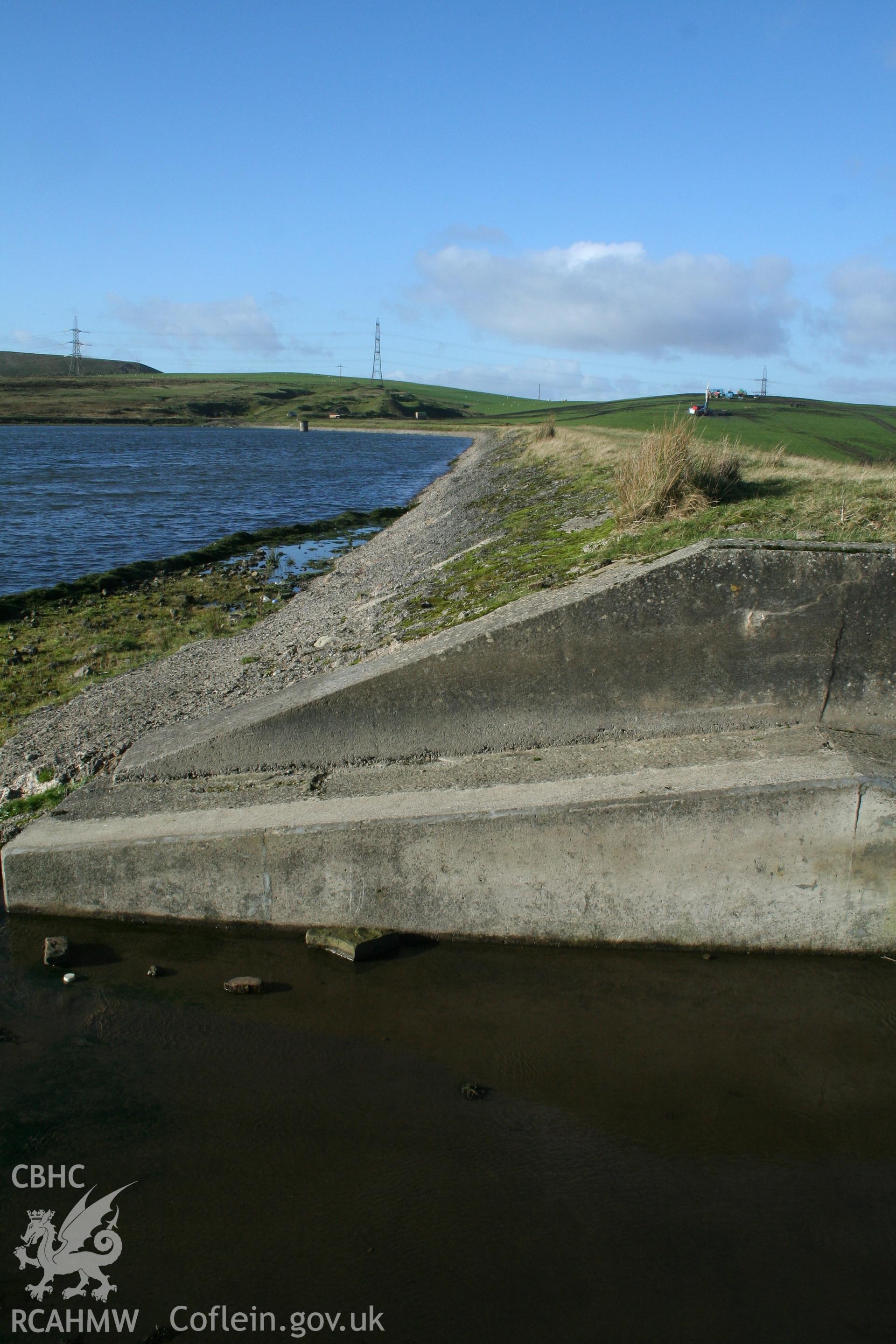 Digital image of Rhaslas Pond and the surrounding area: View of the north dam showing part of the overspill channel, looking west.