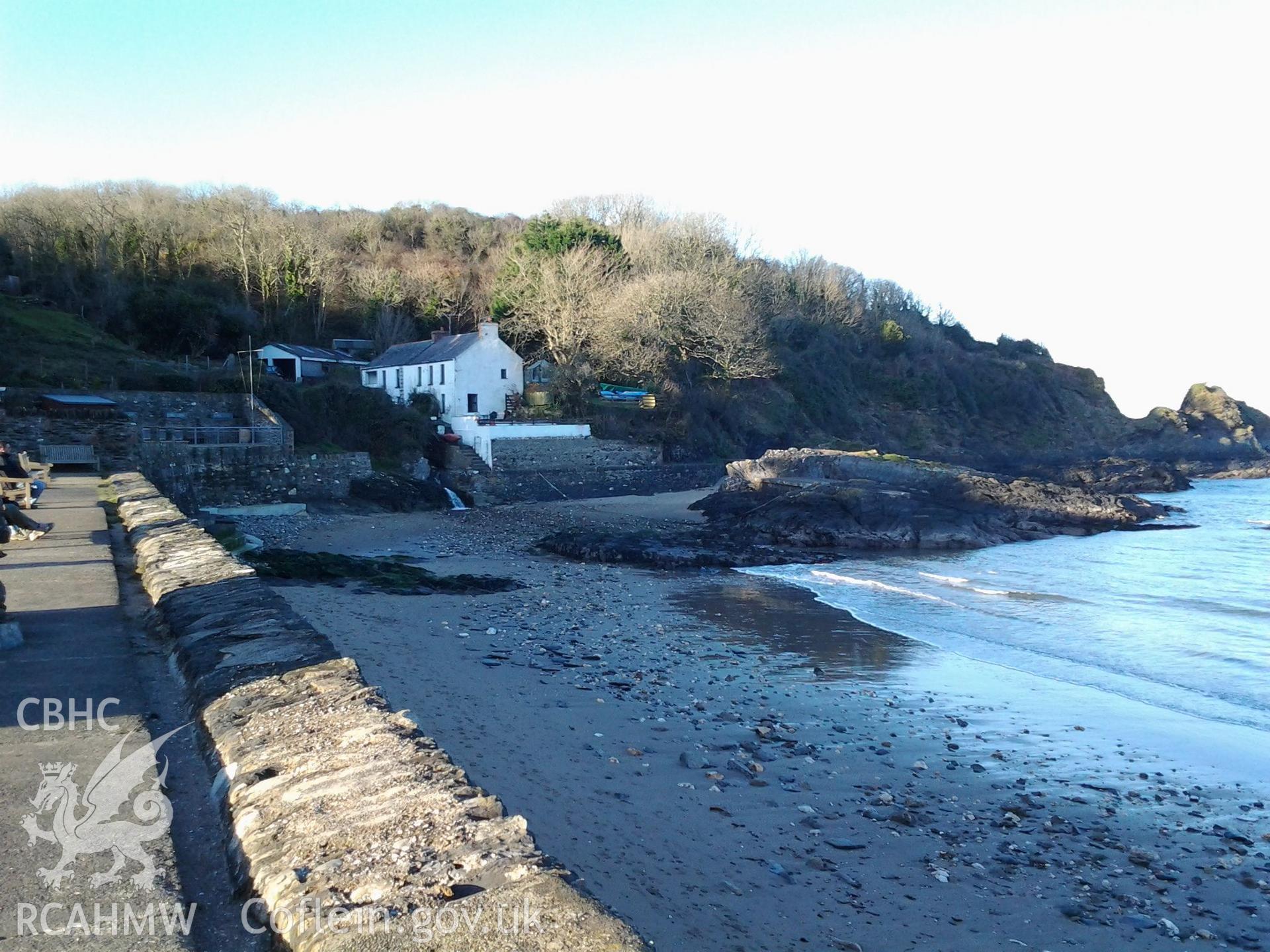 View along the present sea defence wall towards the small tidal harbour and former location of a small shipyard