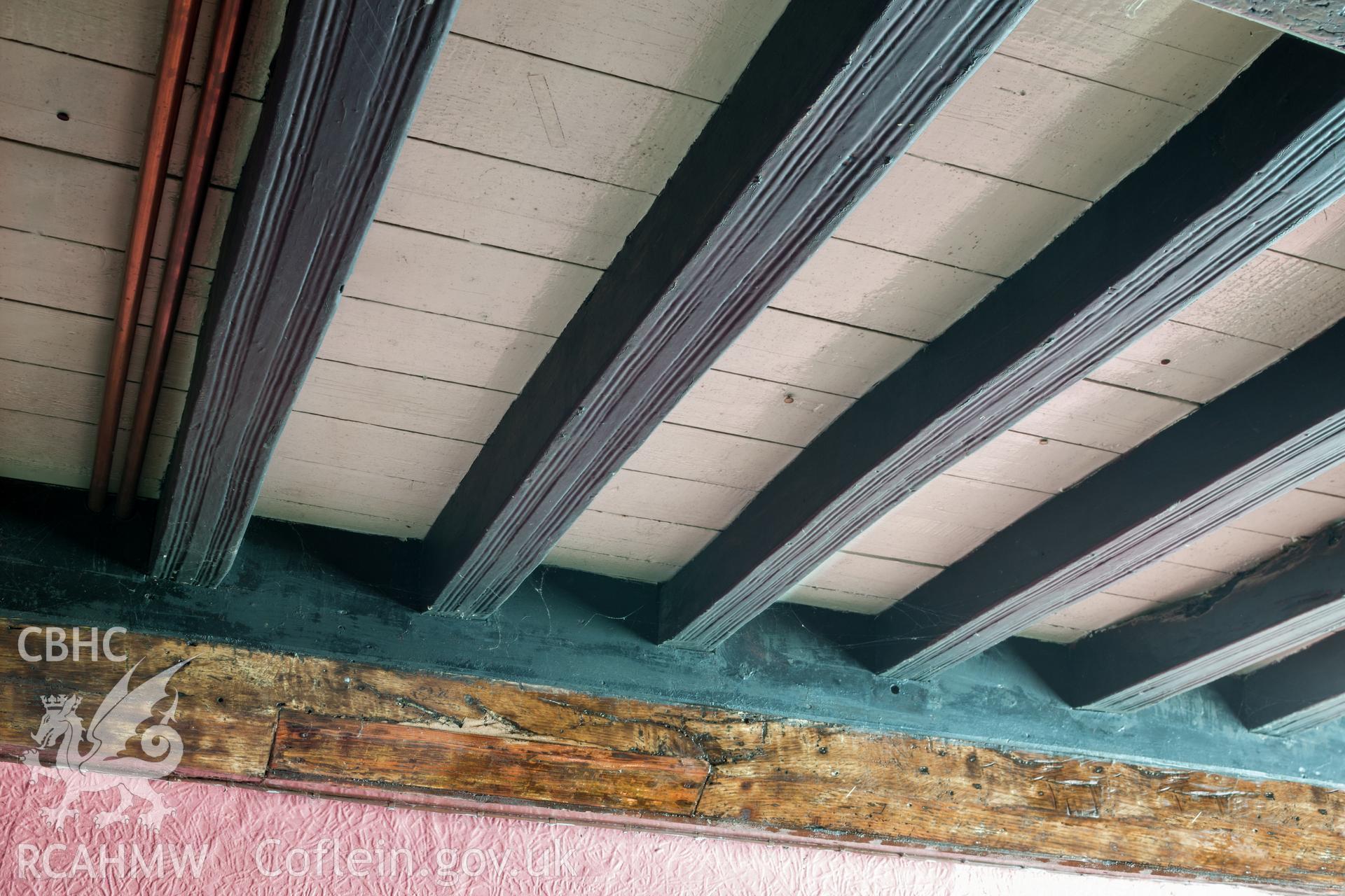 Detail showing pencil moulding on ceiling joists