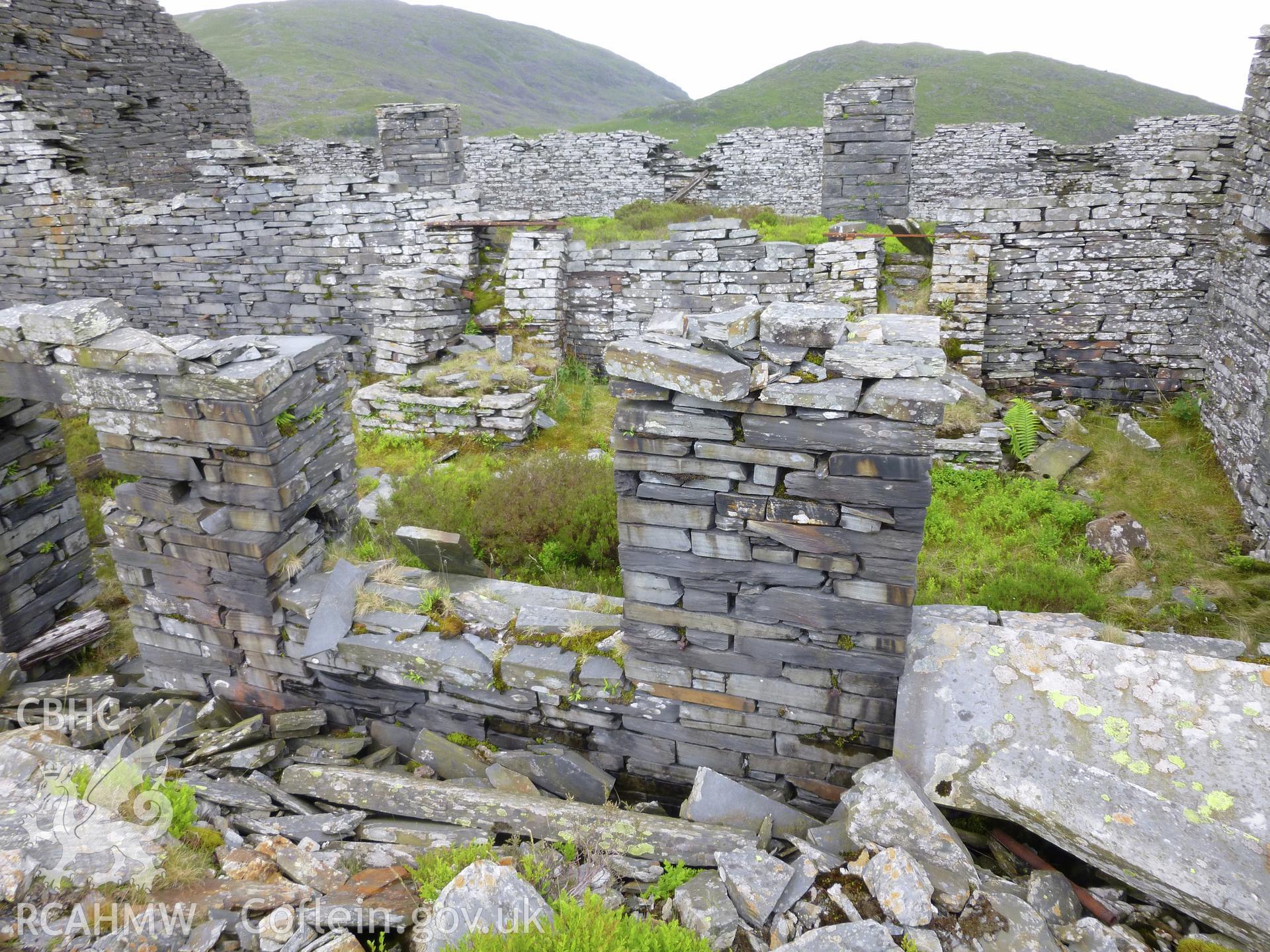 View looking south into smithy attached to the north side of the mill, showing the two hearths.