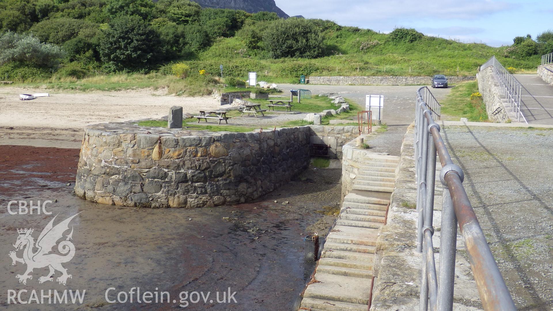 Small dock on south side of pier with large stone mooring bollard
