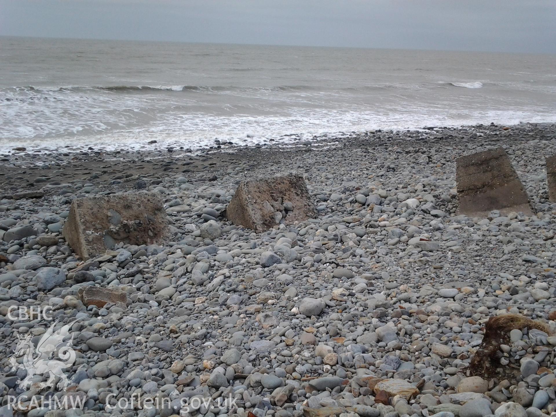 Toppled blocks showing the internal components - large beach cobbles.