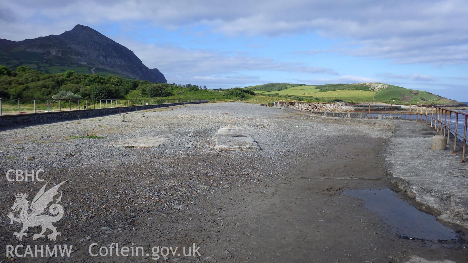 View to landward along Trefor pier with concrete foundations for former loading conveyor in foreground