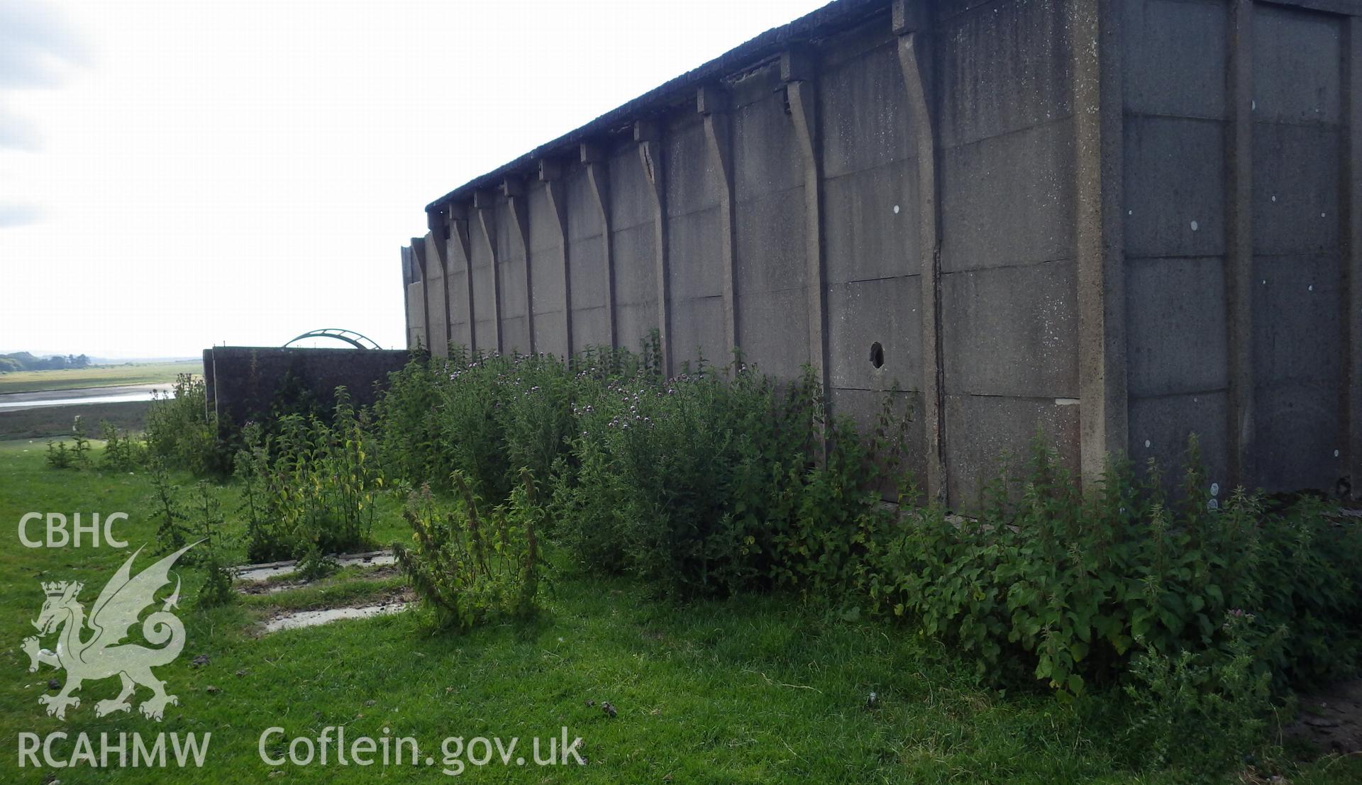 Eastern facade of BCF hut with concrete foundation and ancilliary enclosure