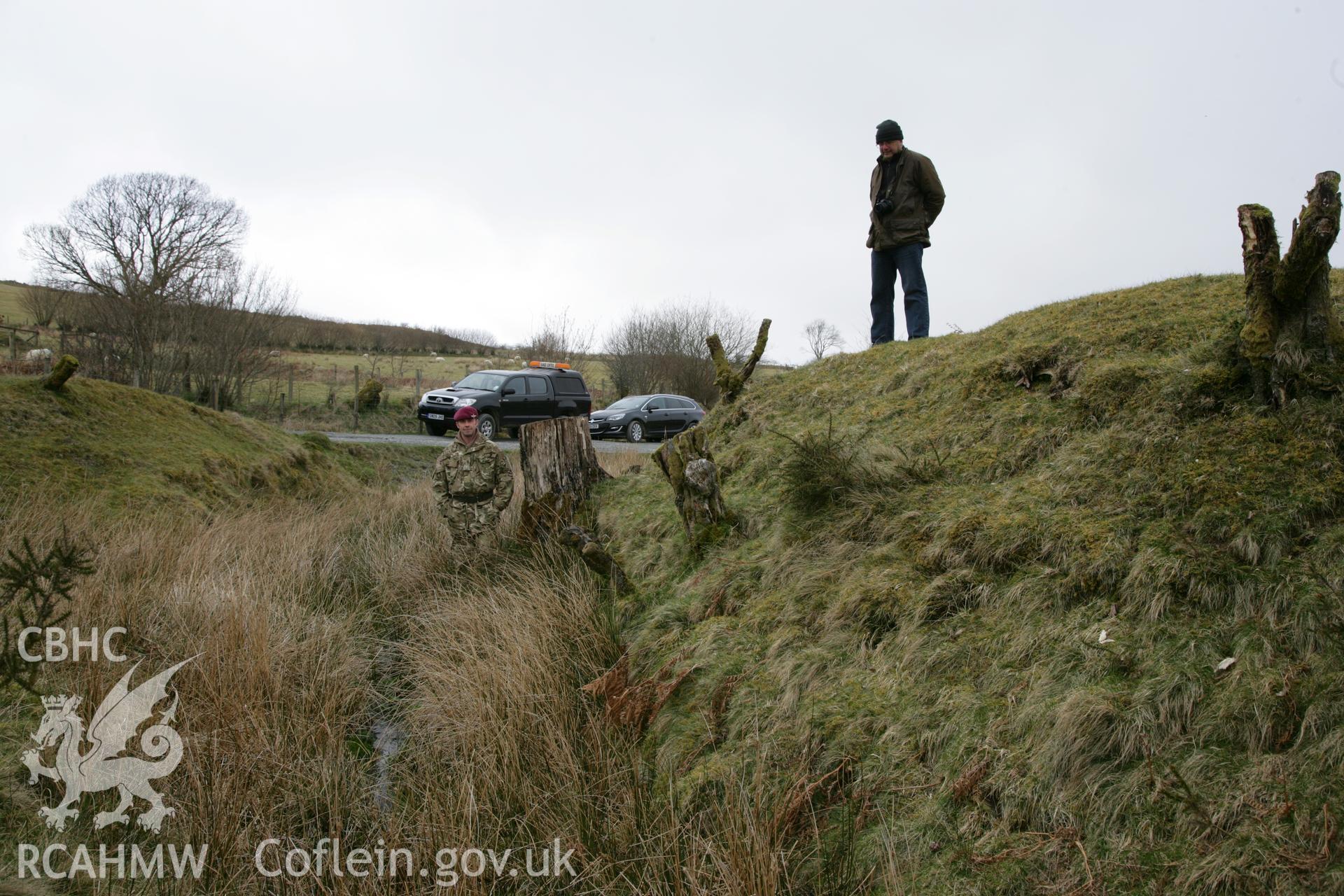 Clawdd British, rampart on north-west side, with figures for scale