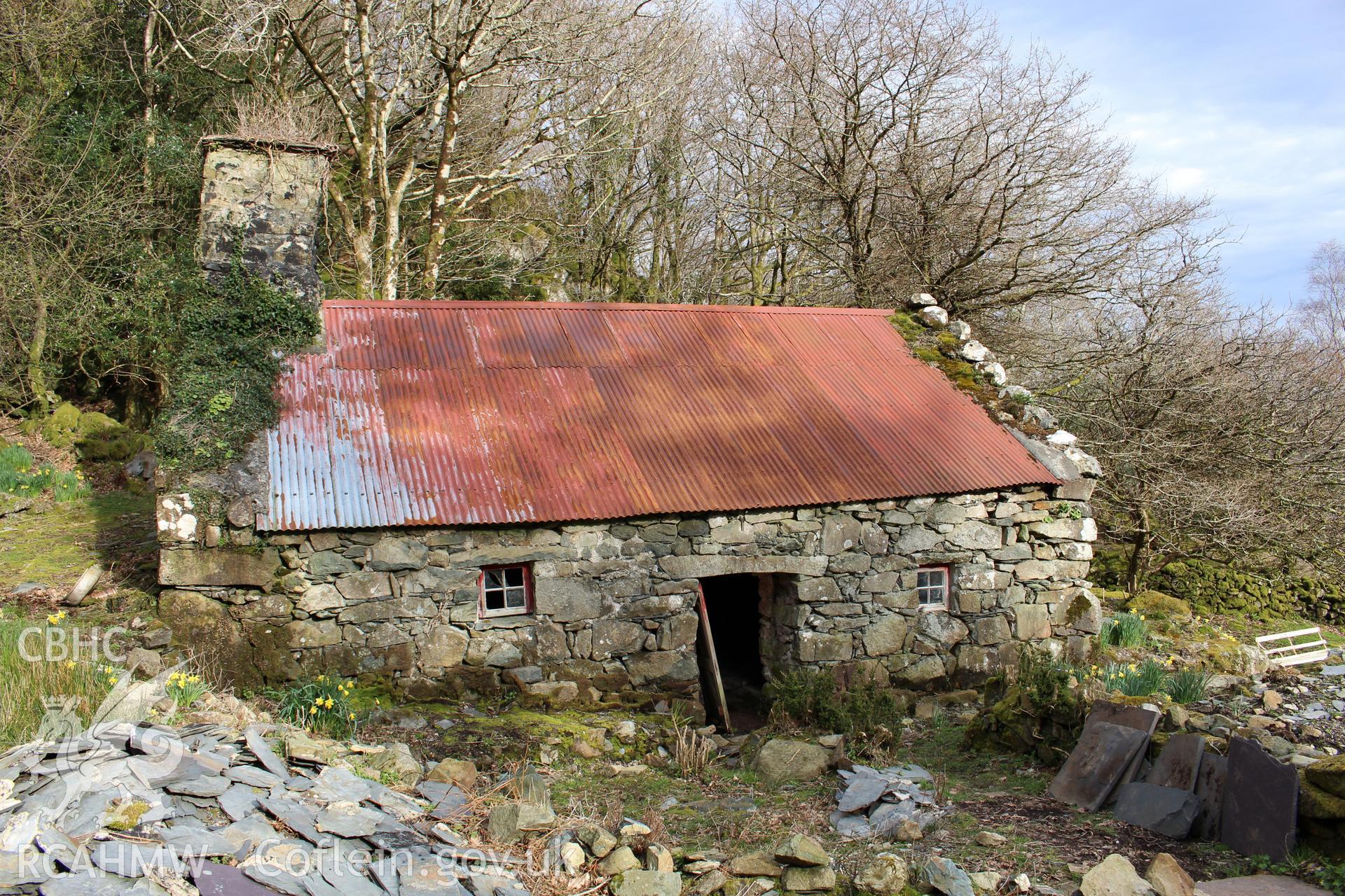 Exterior: west elevation, with roofing slates in foreground.