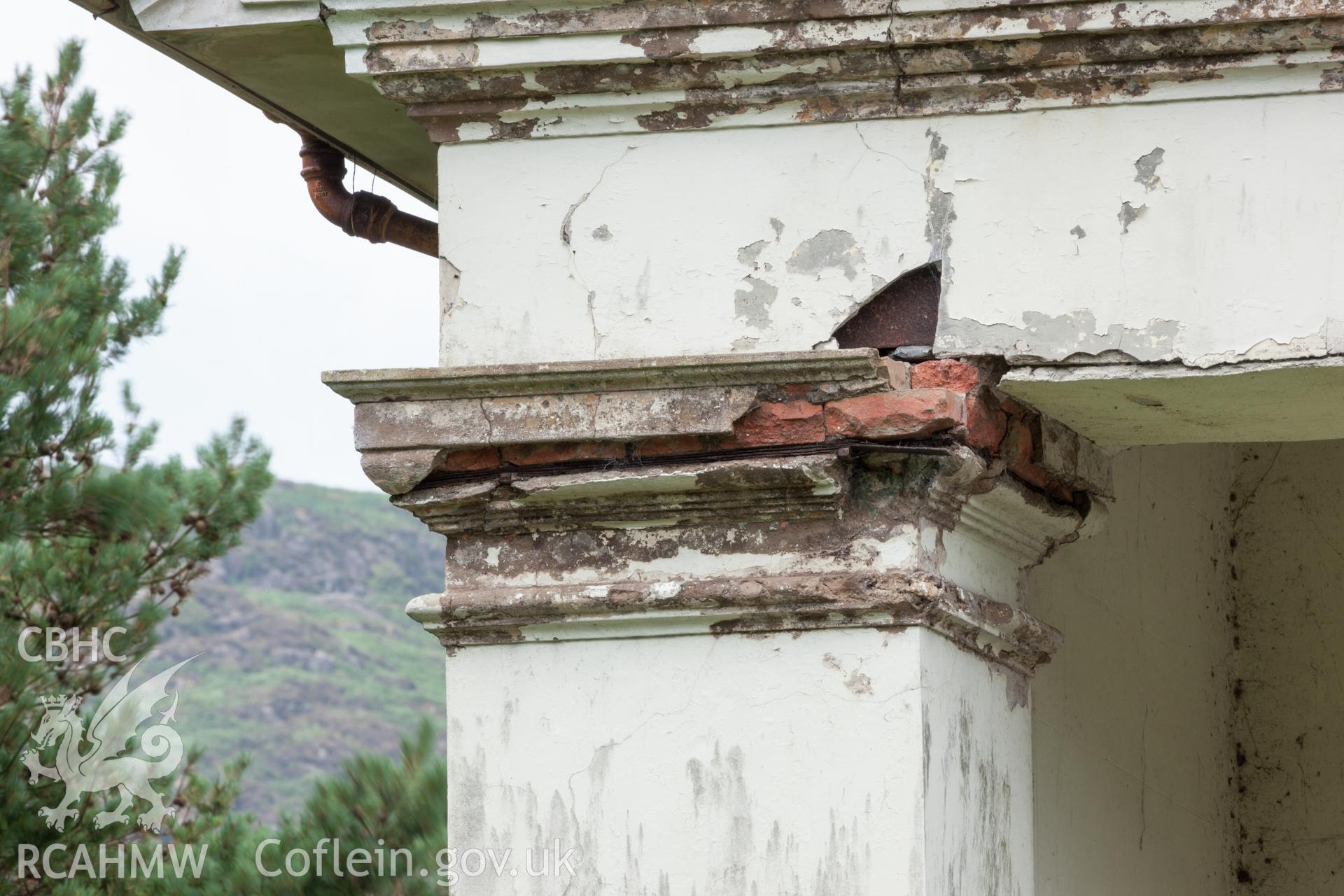 Detail of construction / damage on square column capital