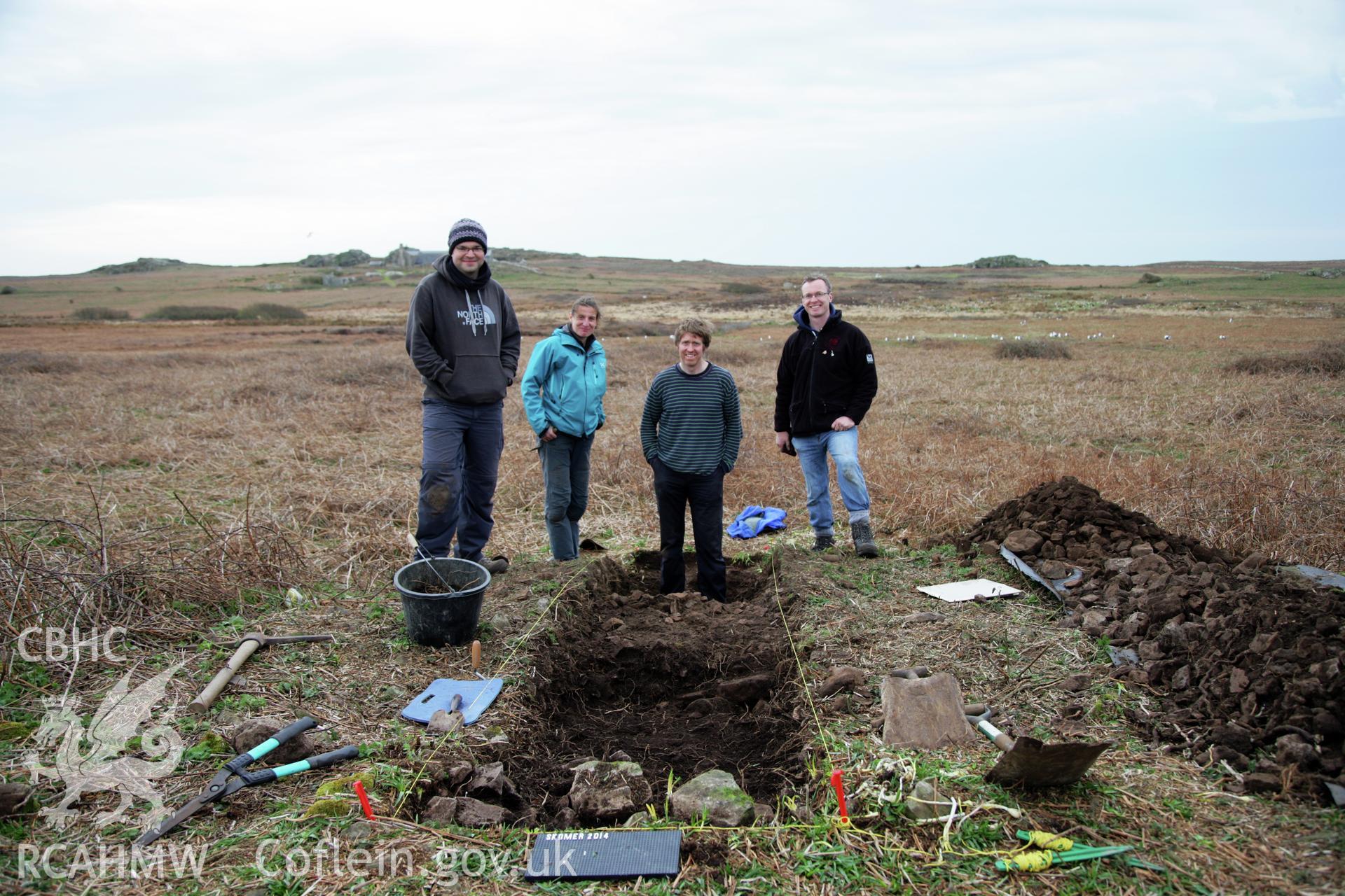 Skomer Island excavation of a burnt stone mound, Hut Group 8. Skomer Island Project team L-R, O. Davis, L. Barker, B. Johnston and T. Driver