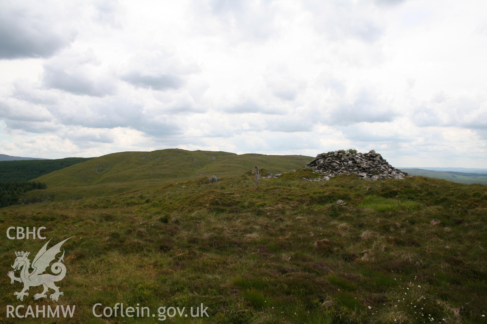 View from the north with, on the horizon, other hilltop cairns in the Moel-y-llyn cemetery (NPRN 418793).