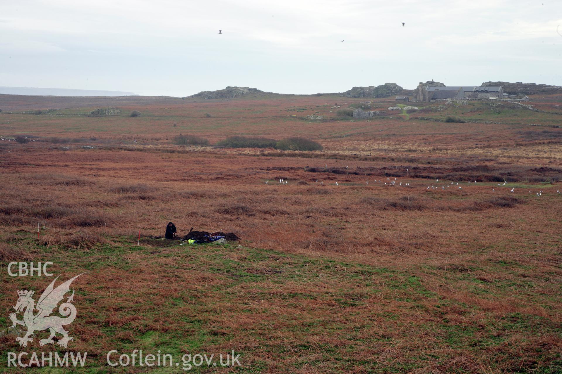 Skomer Island excavation of a burnt stone mound, Hut Group 8. General view of excavation trench from the north-west, looking towards the old farm