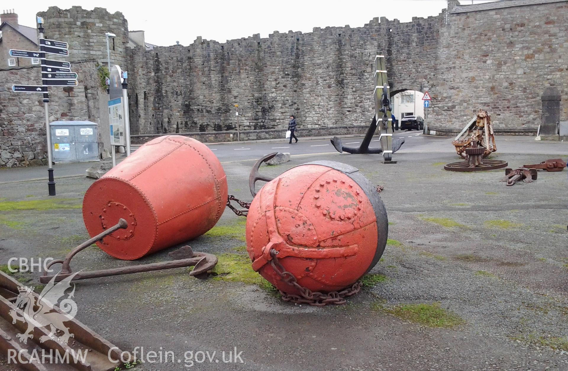 Menai Strait navigation buoys with anchors and large anchor of HMS CONWAY in background