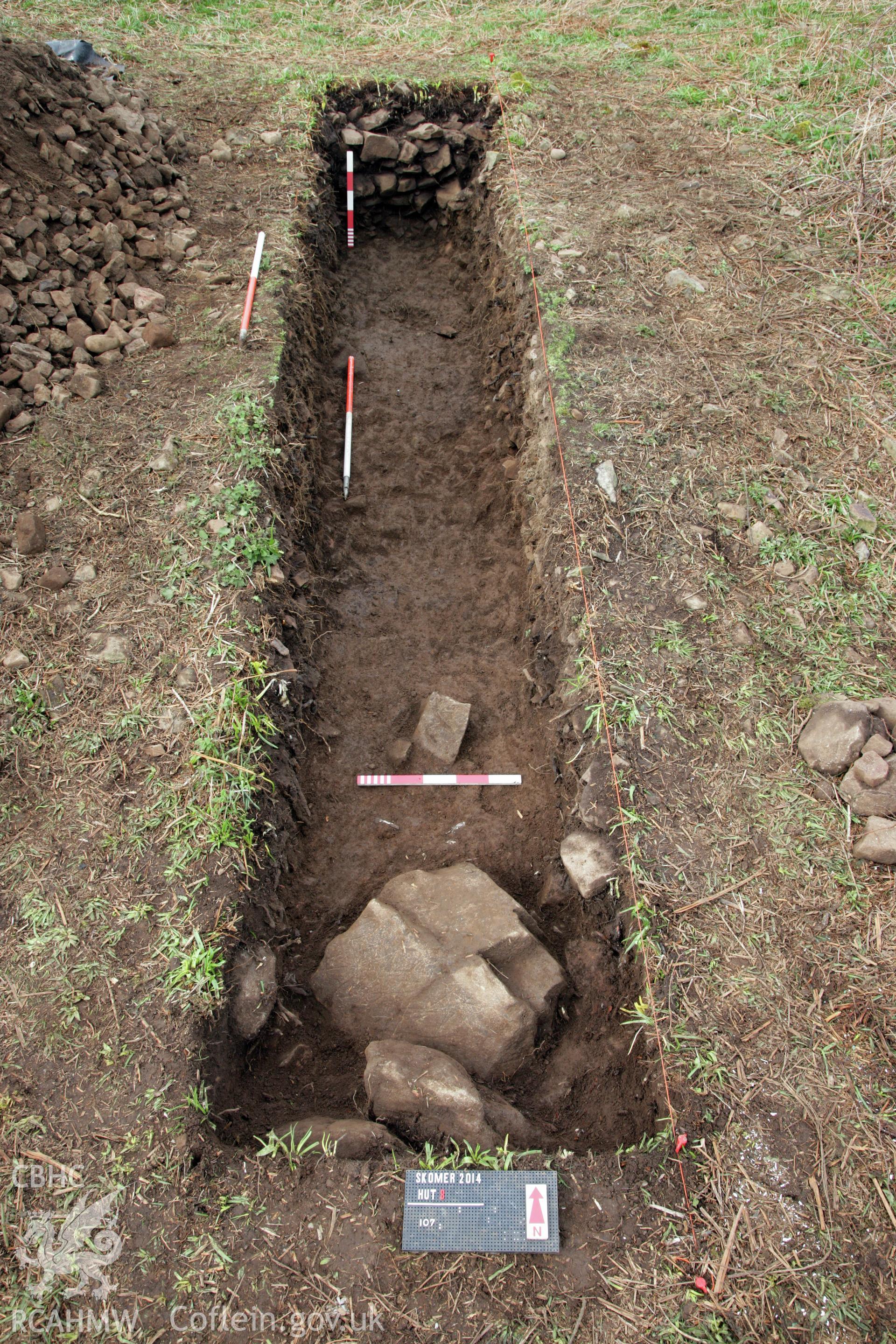 Skomer Island excavation of a burnt stone mound, Hut Group 8. Post excavation photo of the trench from the south showing southern revetment stones