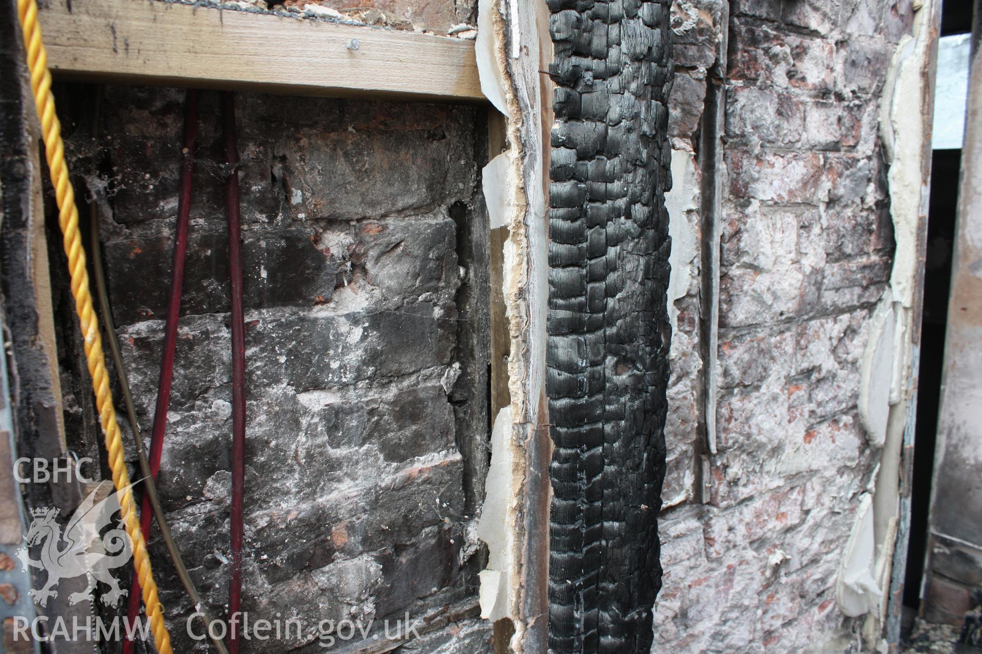 Inner room end wall, blocked 19th C window at first-floor.