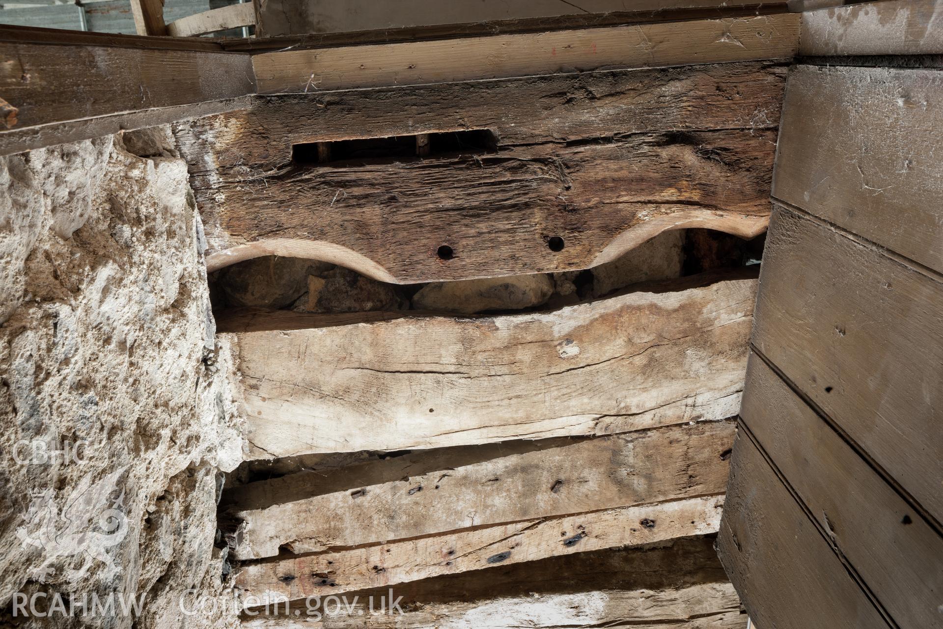 Old frame re-used as door lintel