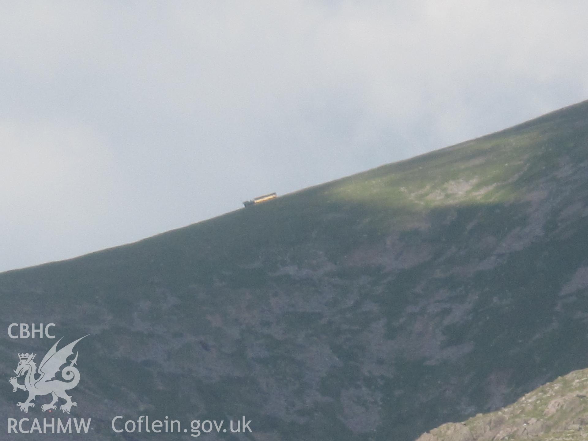 Distant view of a train on the Snowdon Mountain Railway from the west.