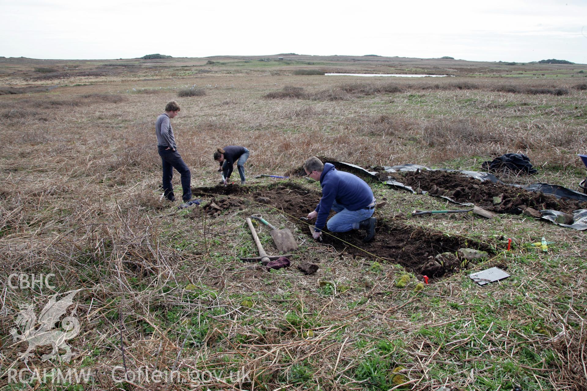 Skomer Island excavation of a burnt stone mound, Hut Group 8. Excavation trench from the north-east