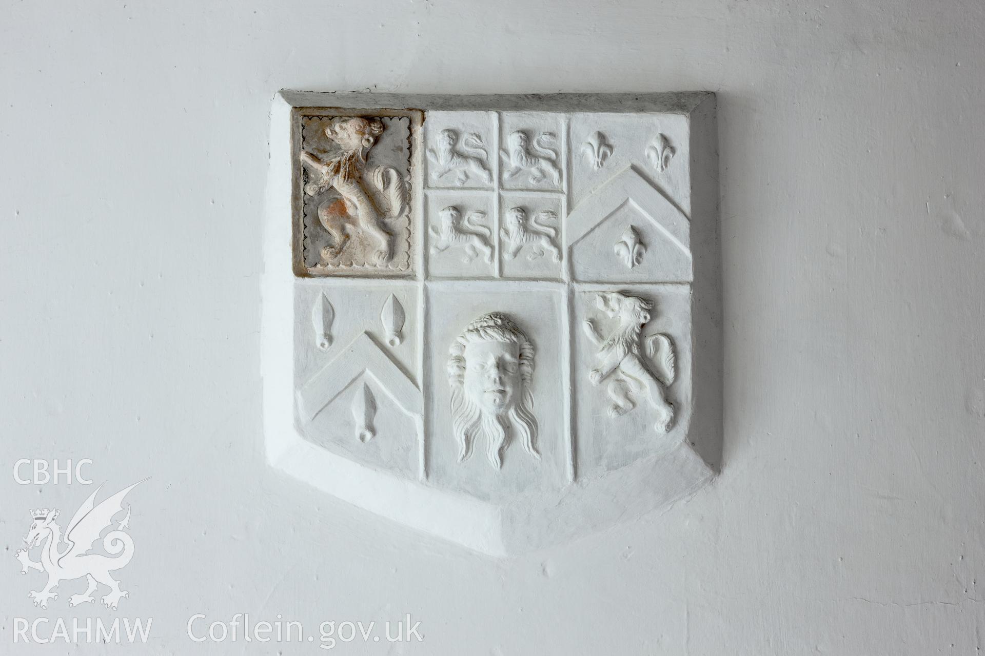 Plaster armorial panel in upper room