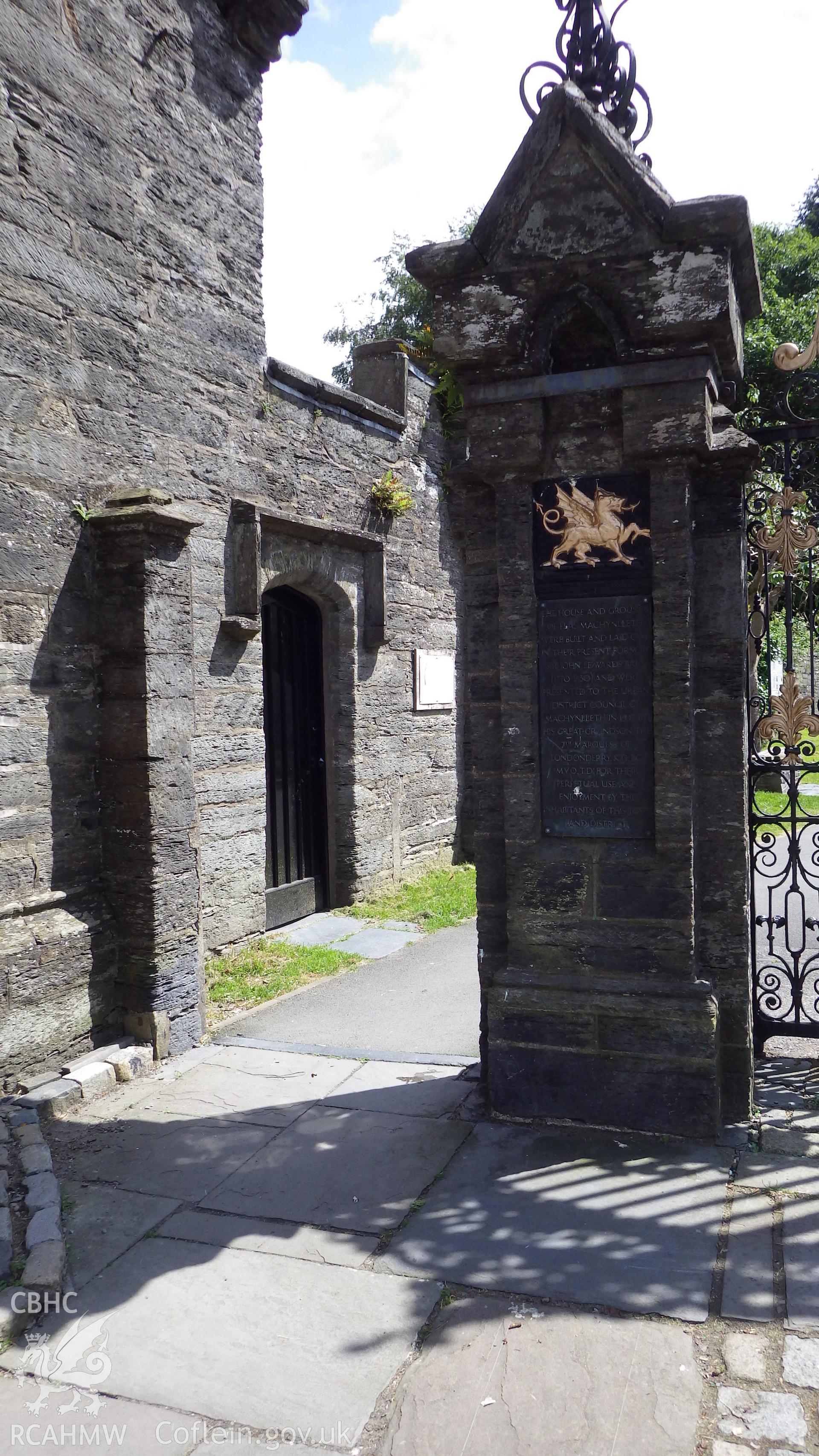 Wall of 64 Heol Maengwyn and eastern gate pier featuring commemorative plaque