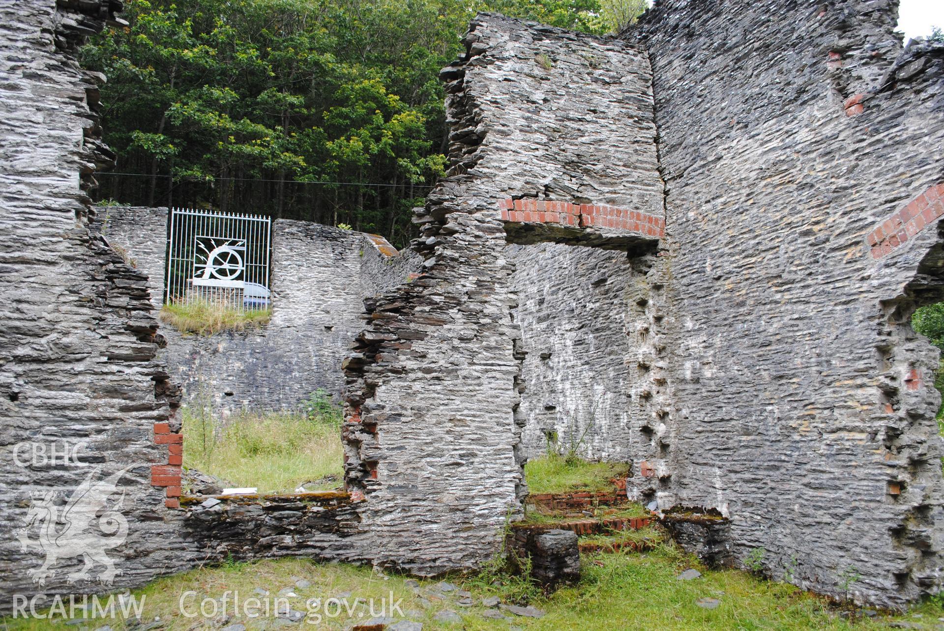 Interior view of wall with coal chute and doorway  seperating the coal store from the boiler room.