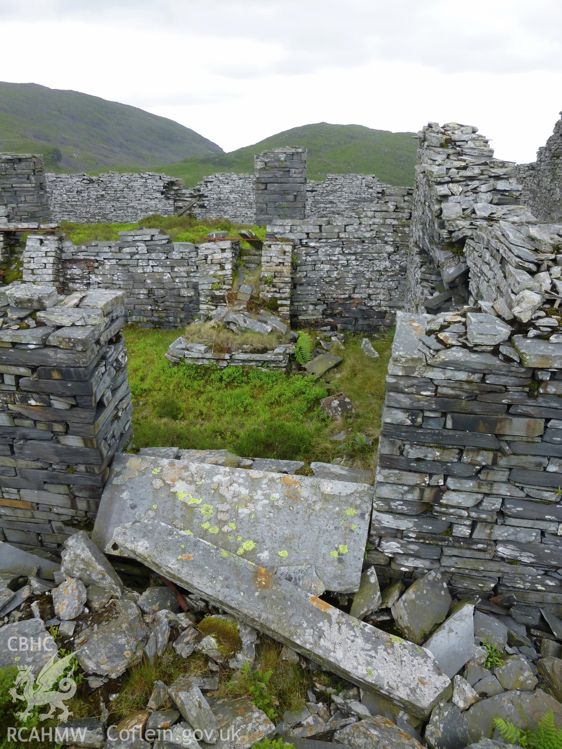 View looking south into smithy attached to the north side of the mill, showing one of two hearths.