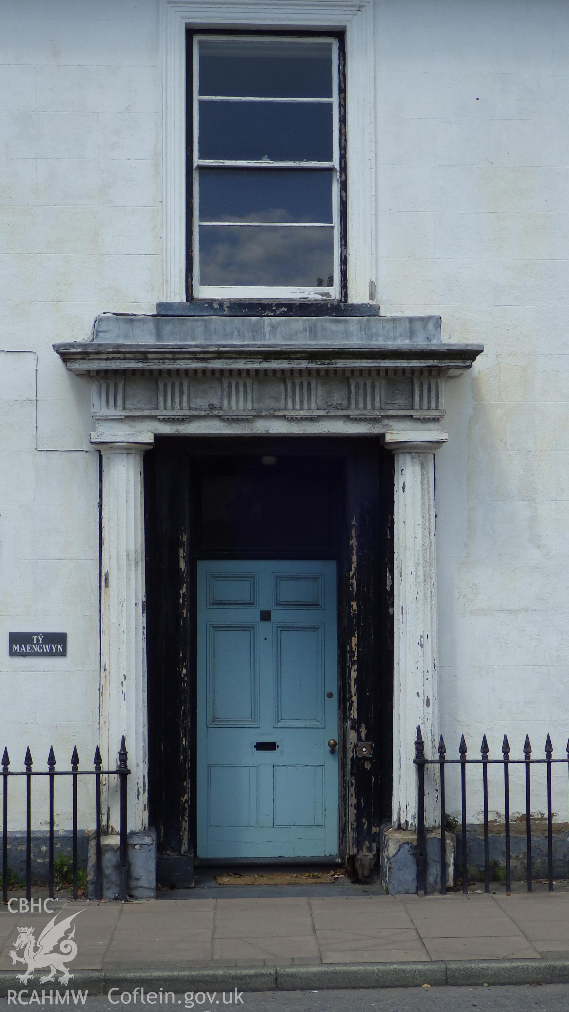 View of front door with doric columns and window above