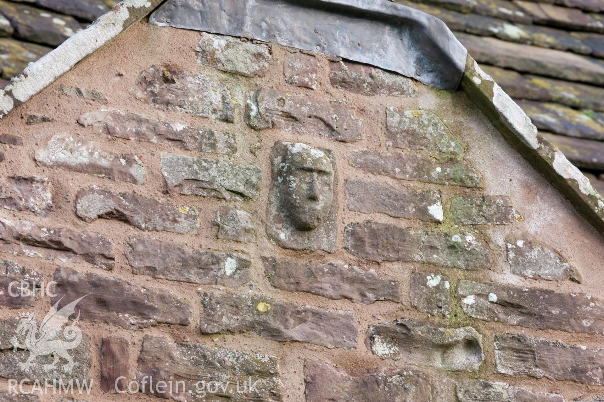 Detail of carved head over porch