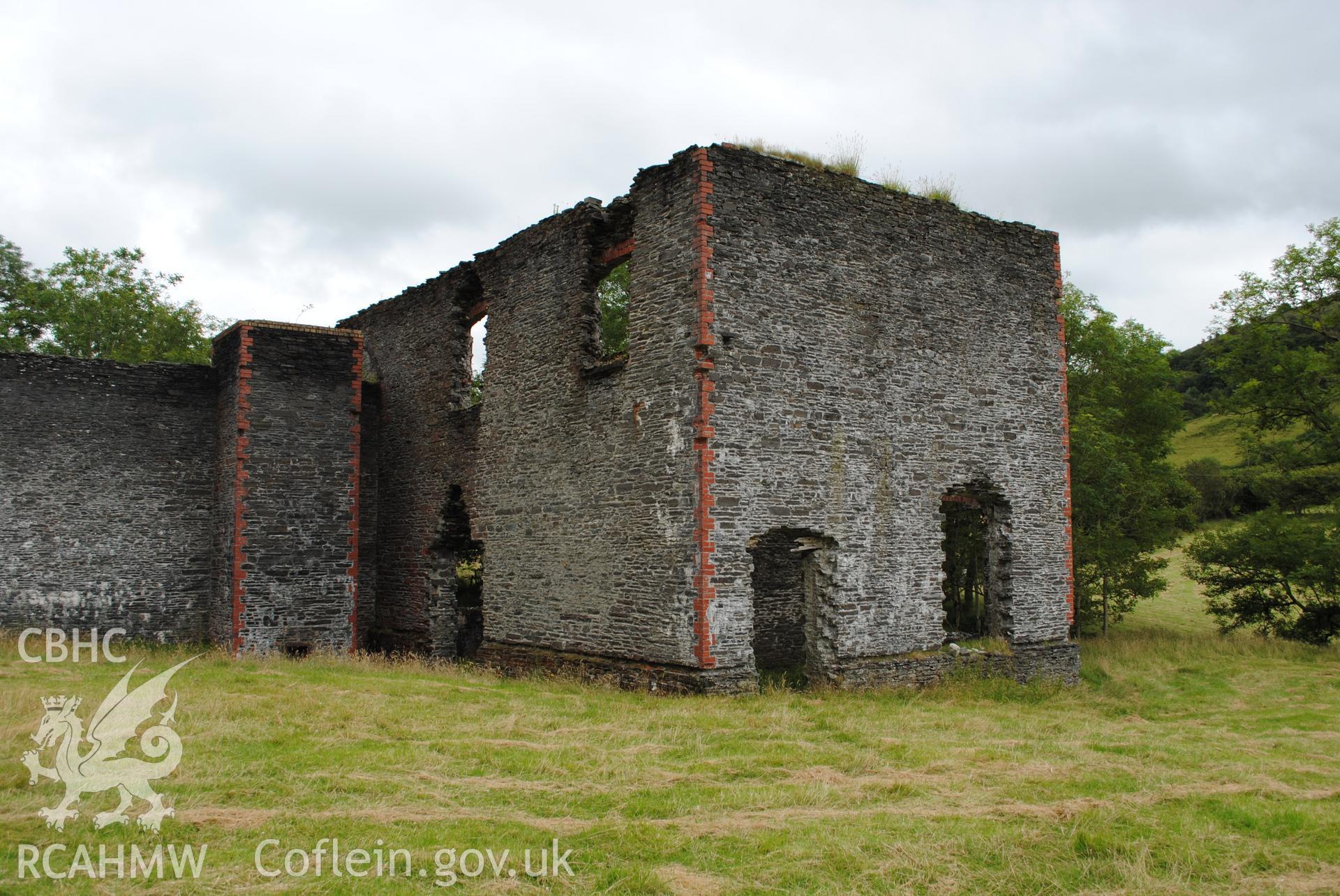 Exterior view of boiler room chimney, machine room and store from the west,