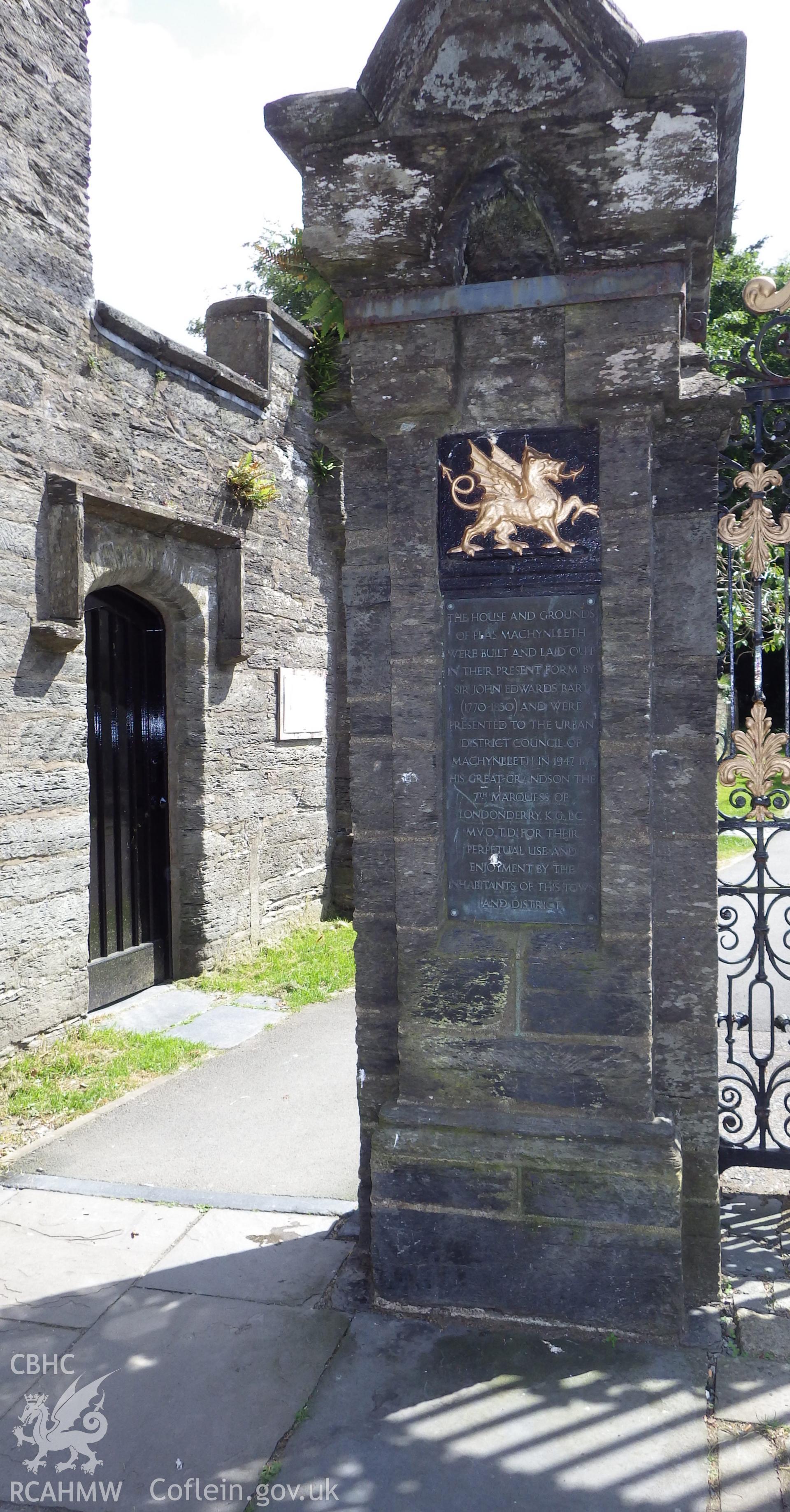 Wall of 64 Heol Maengwyn and eastern gate pier featuring plaque commemorating the gift of Y Plas to town