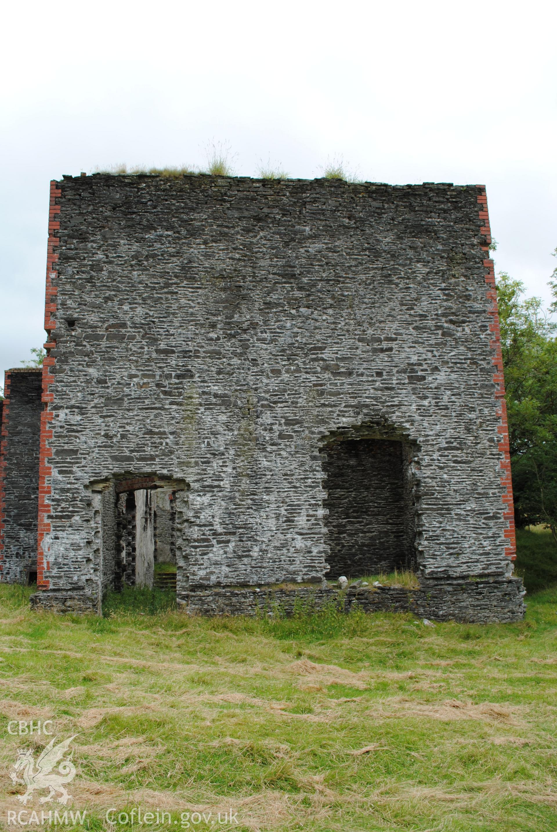 Exterior view of store with office and kitchen above from the west.