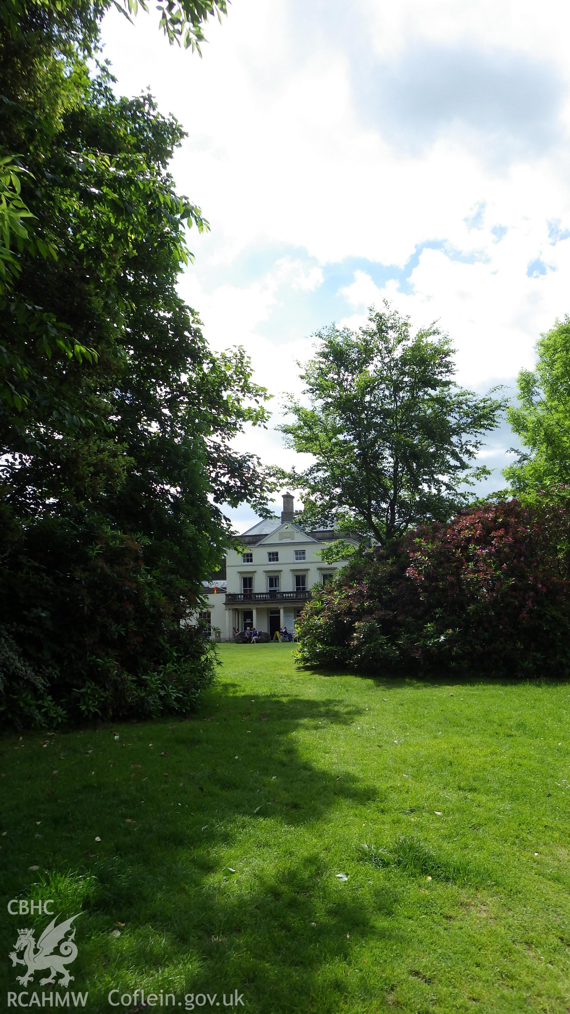 Front elevation viewed through shrub plantings